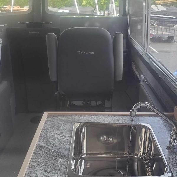 Interior of 2024 Spartan 2600 Olympia with sink and captain's chair.