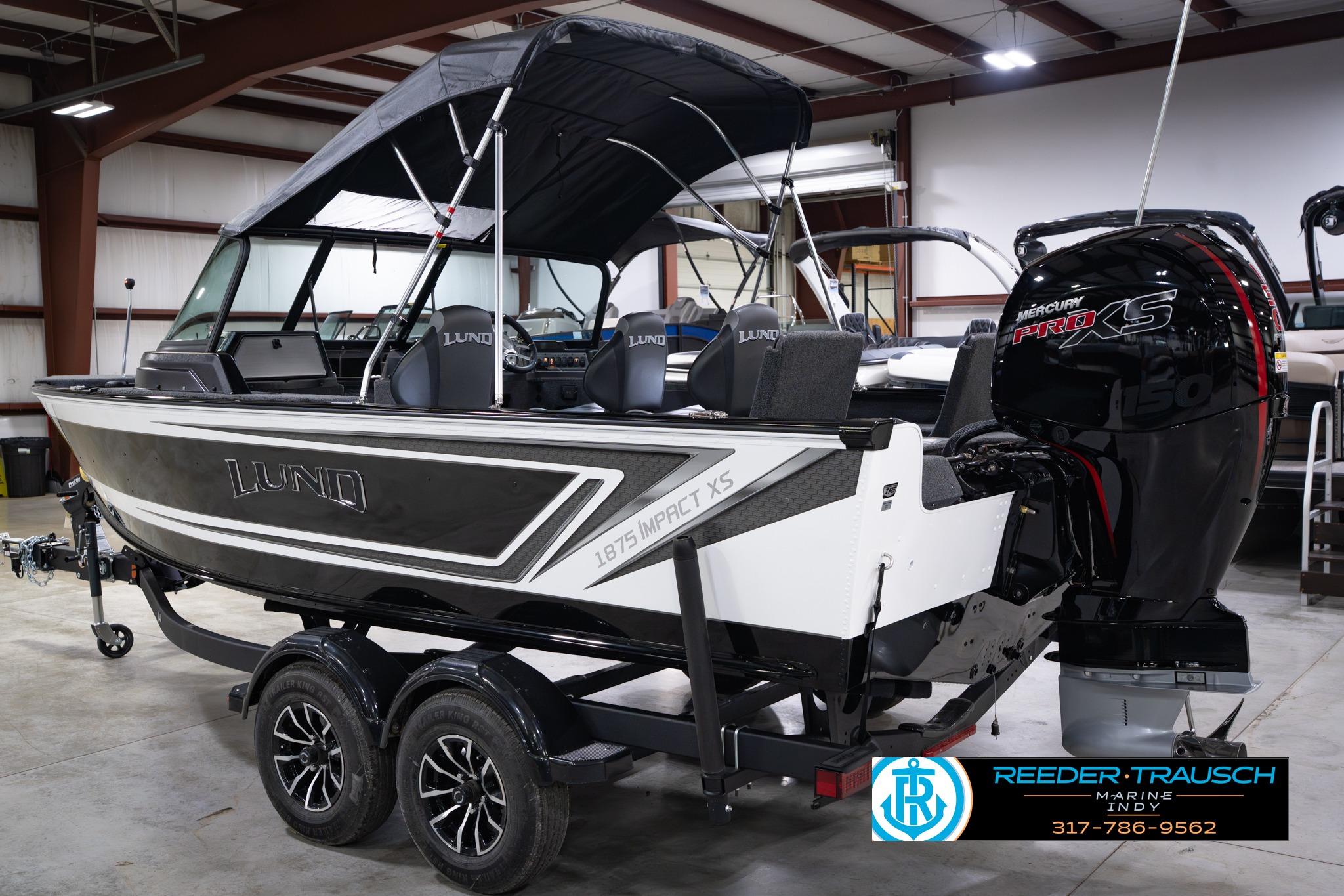 2026 Lund 1875 Impact XS SS boat with Mercury Pro XS engine in showroom.