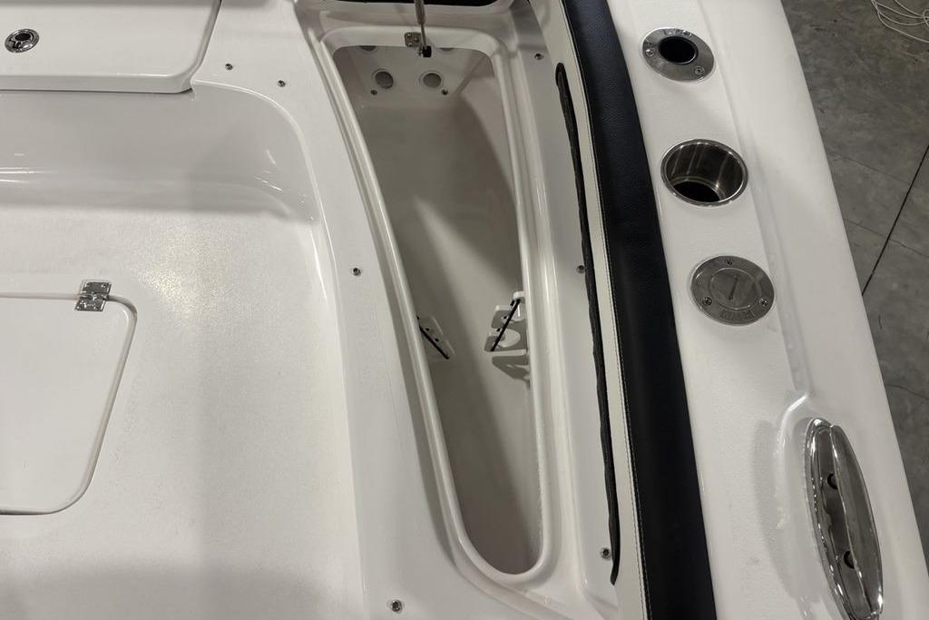 2026 Tidewater 2300 Carolina Bay boat interior with storage compartment and cup holders.