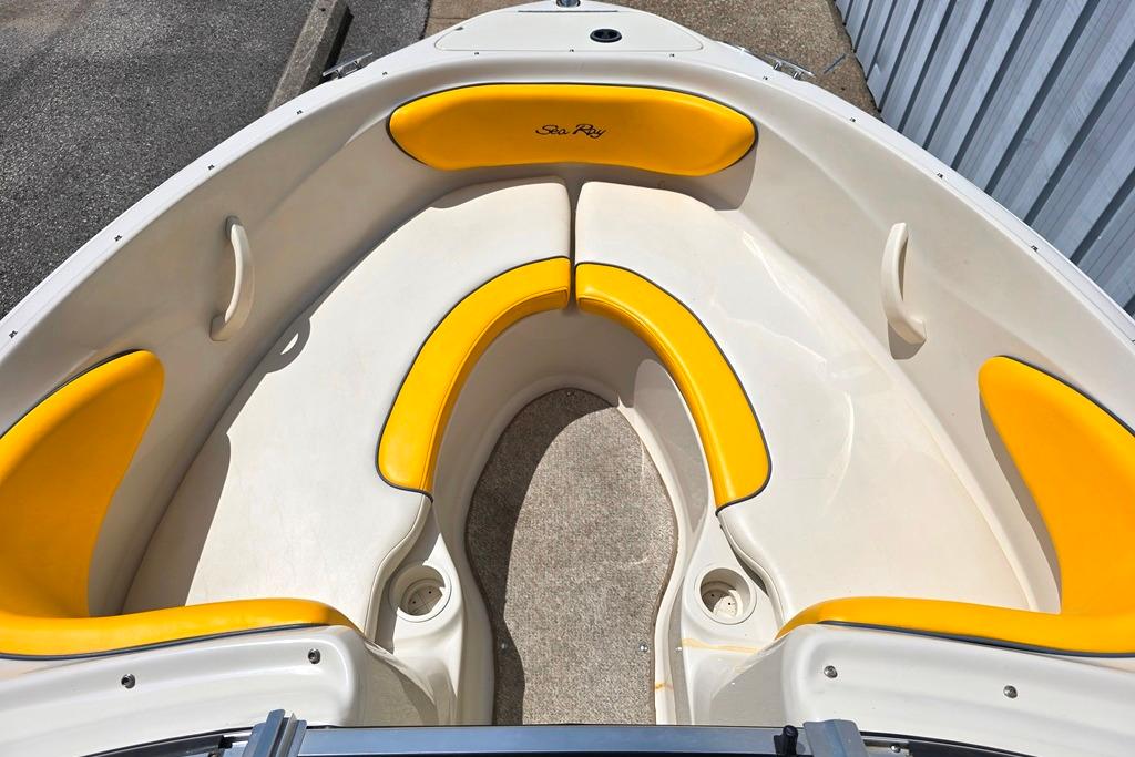 2007 Sea Ray 205 Sport boat interior with yellow cushioned seating.