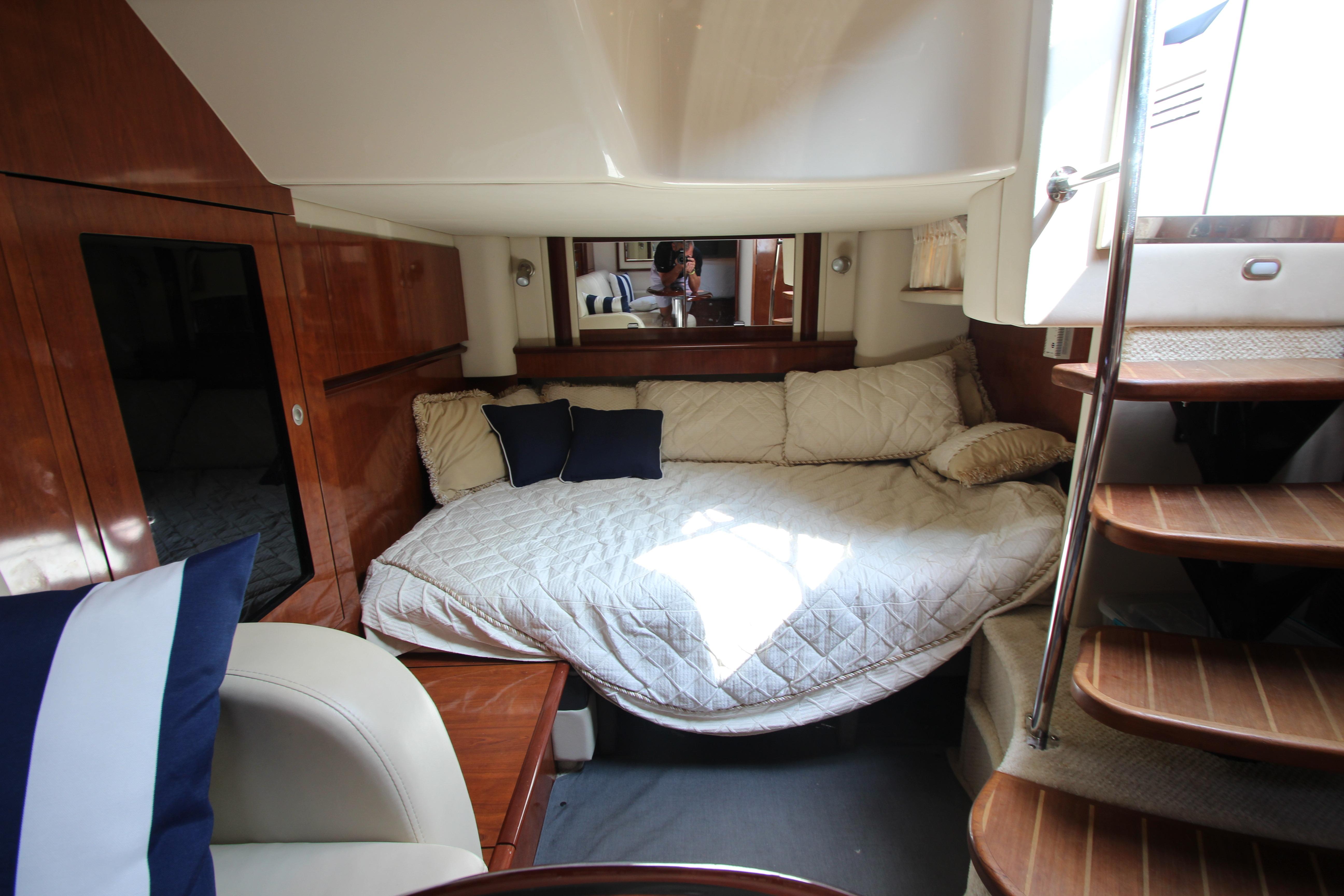 Luxurious cabin interior of 2004 Sea Ray 40 Sundancer yacht with cozy bedding.