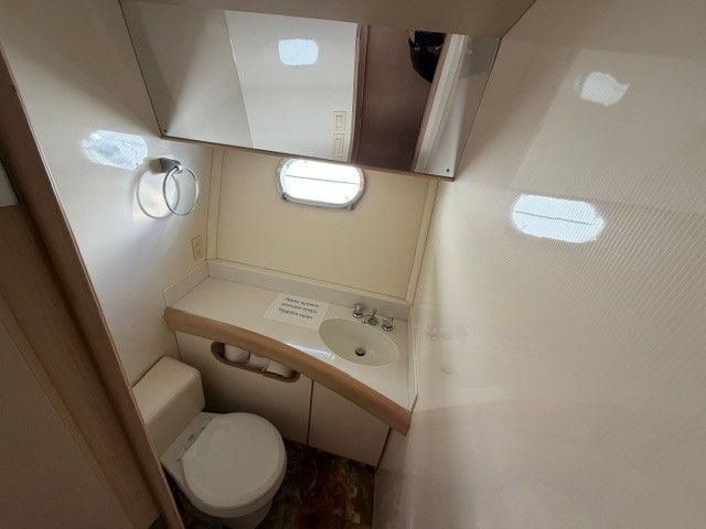 Bathroom of a 1990 Custom MOTOR YACHT with sink and toilet.