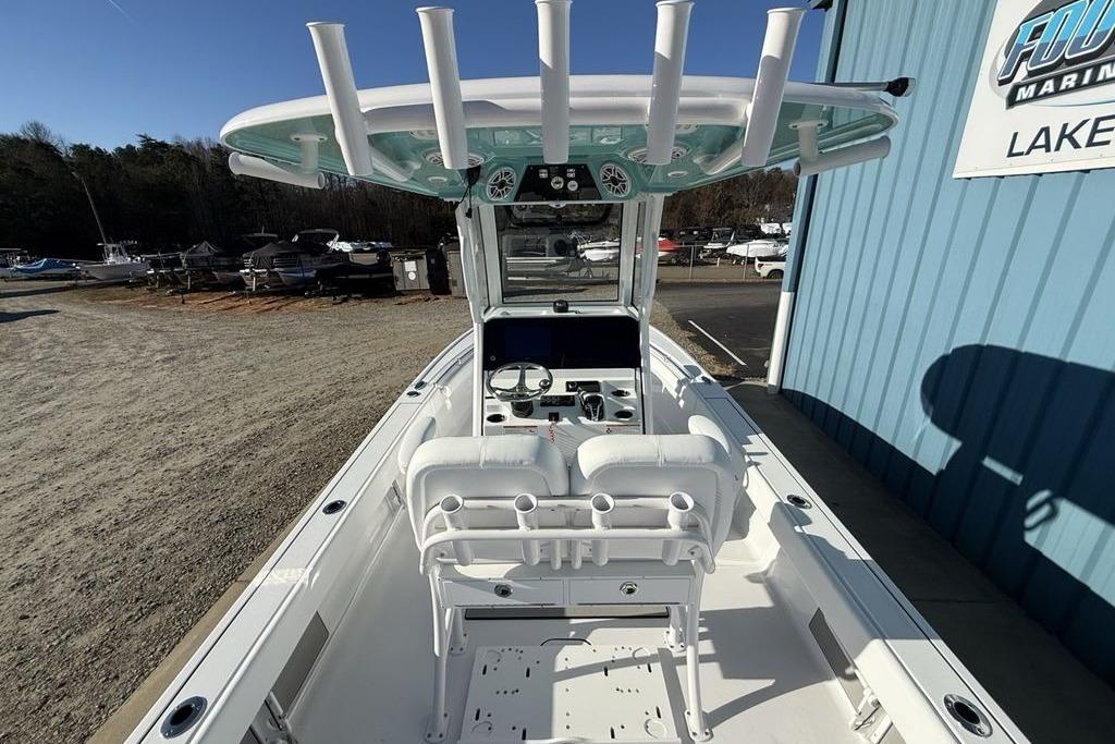 2026 Sportsman Masters 247OE Bay Boat interior with helm and seating, docked outdoors.