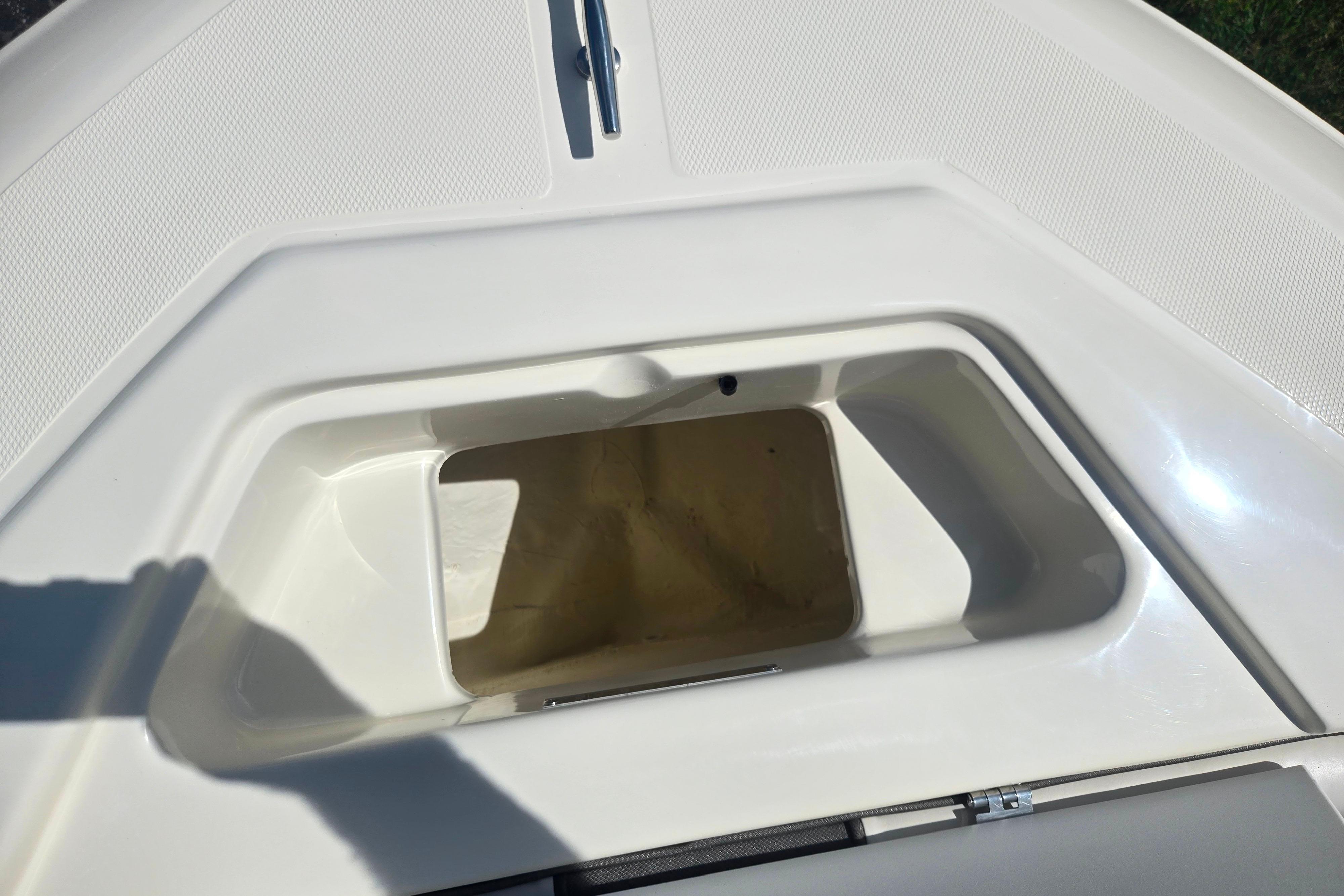Open storage compartment on a 2016 Key Largo 2000CC boat deck.