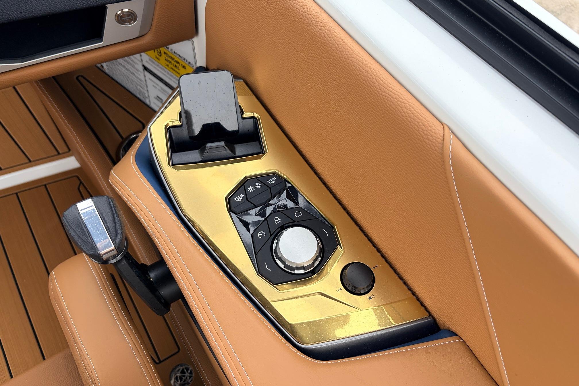 Control panel of 2026 Nautique Super Air Nautique G25 with luxurious tan leather accents.