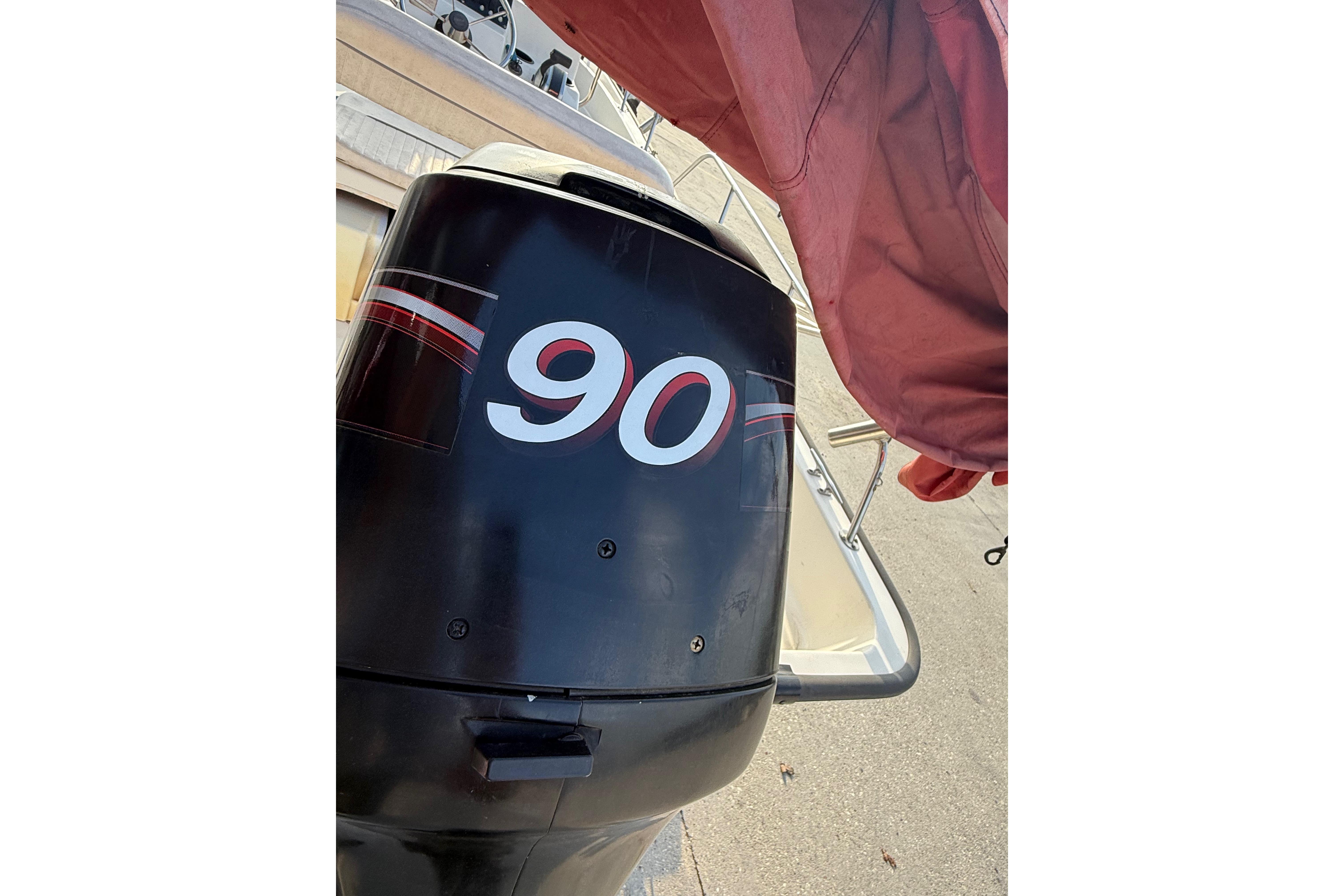 Outboard motor on a 2005 Boston Whaler 17 Montauk boat, featuring a "90" decal.