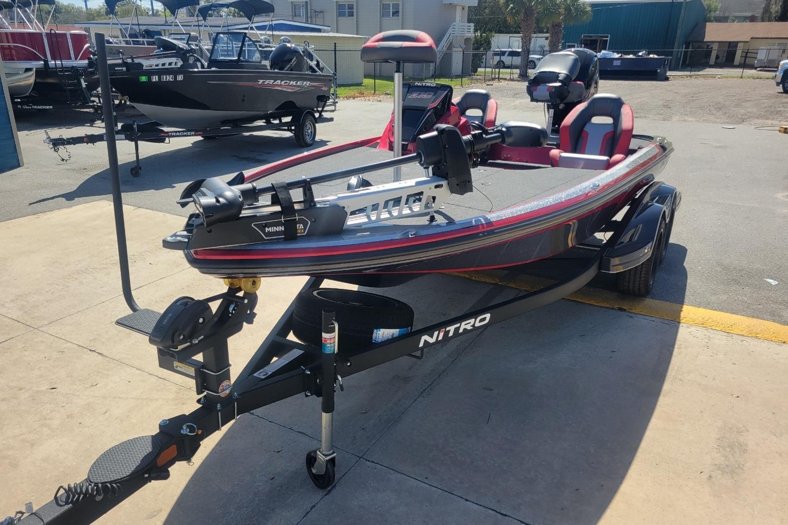 2026 Nitro Z18 boat on trailer, parked outdoors, featuring Minn Kota trolling motor.