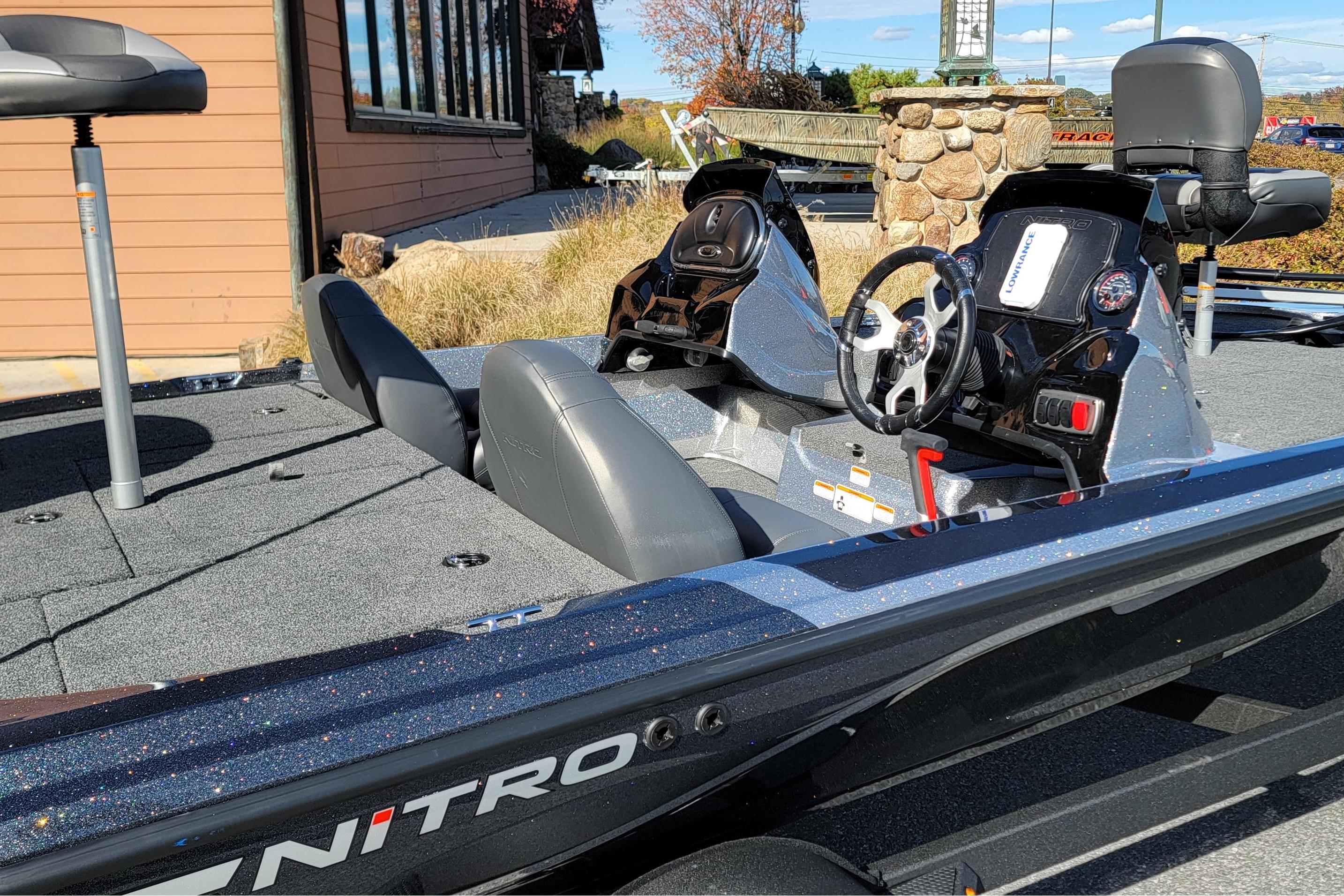 2026 Nitro Z17 boat interior with steering wheel and seating, parked outdoors.