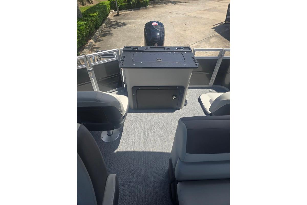 2026 Sun Tracker Fishin' Barge 22 DLX interior with seating and storage.