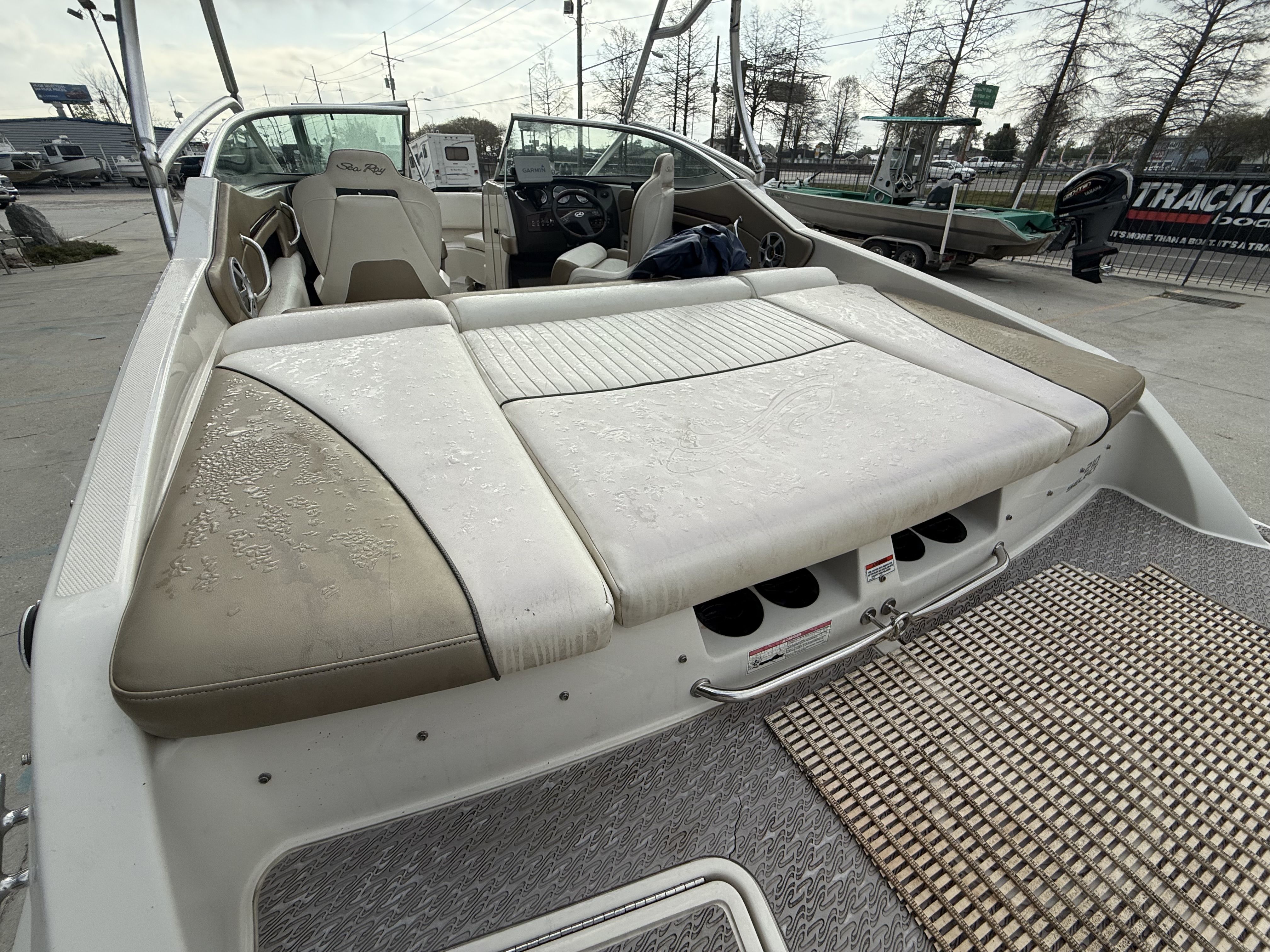 2007 Sea Ray 210 boat with cushioned deck and helm area.