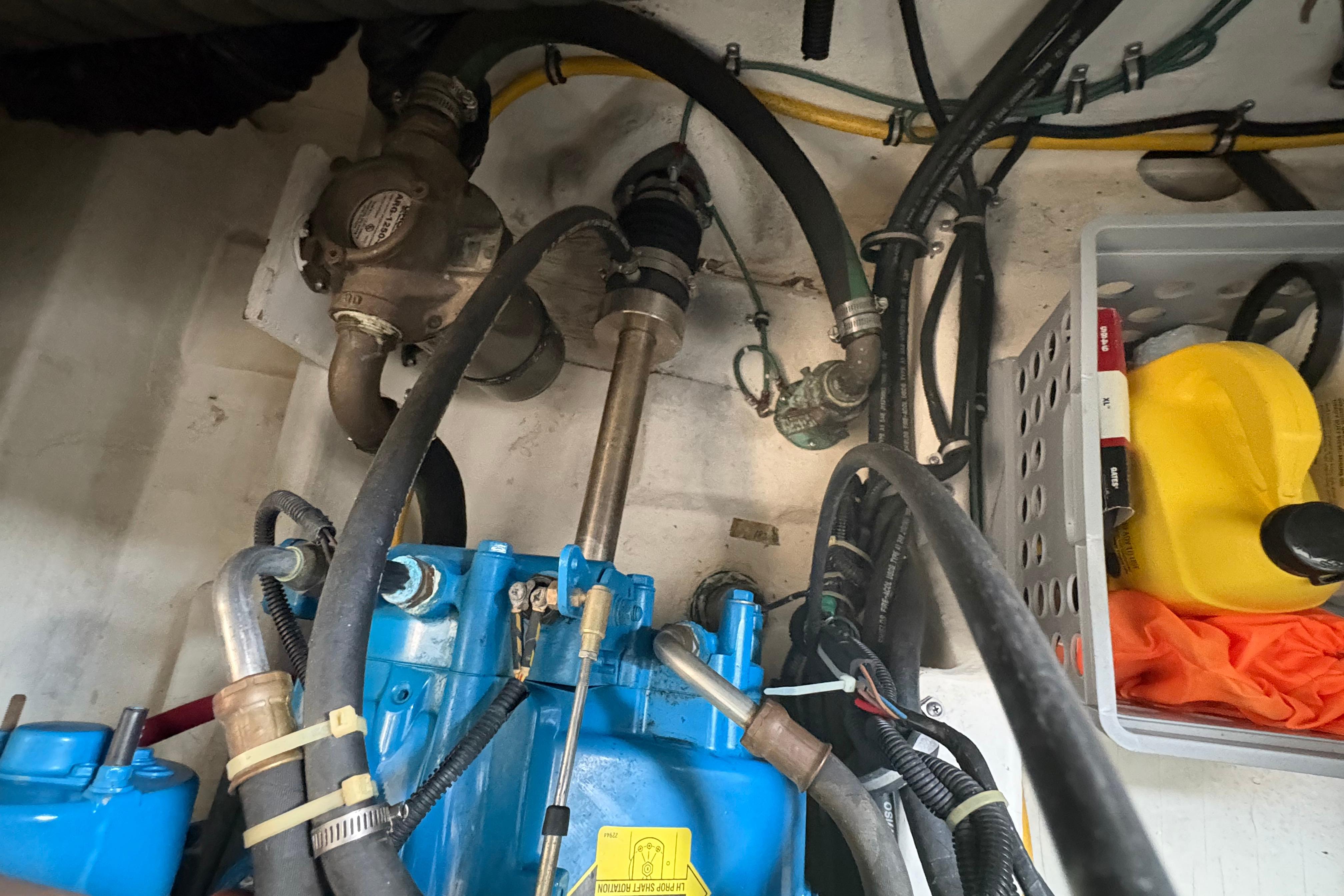 Engine compartment of a 1999 Tiara Yachts 3100 Open with visible hoses and components.
