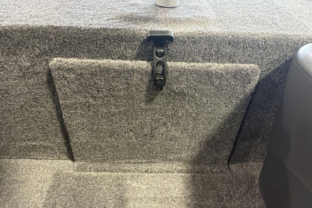 Interior view of 2026 Tracker Bass Tracker Classic XL boat, featuring carpeted storage compartment.
