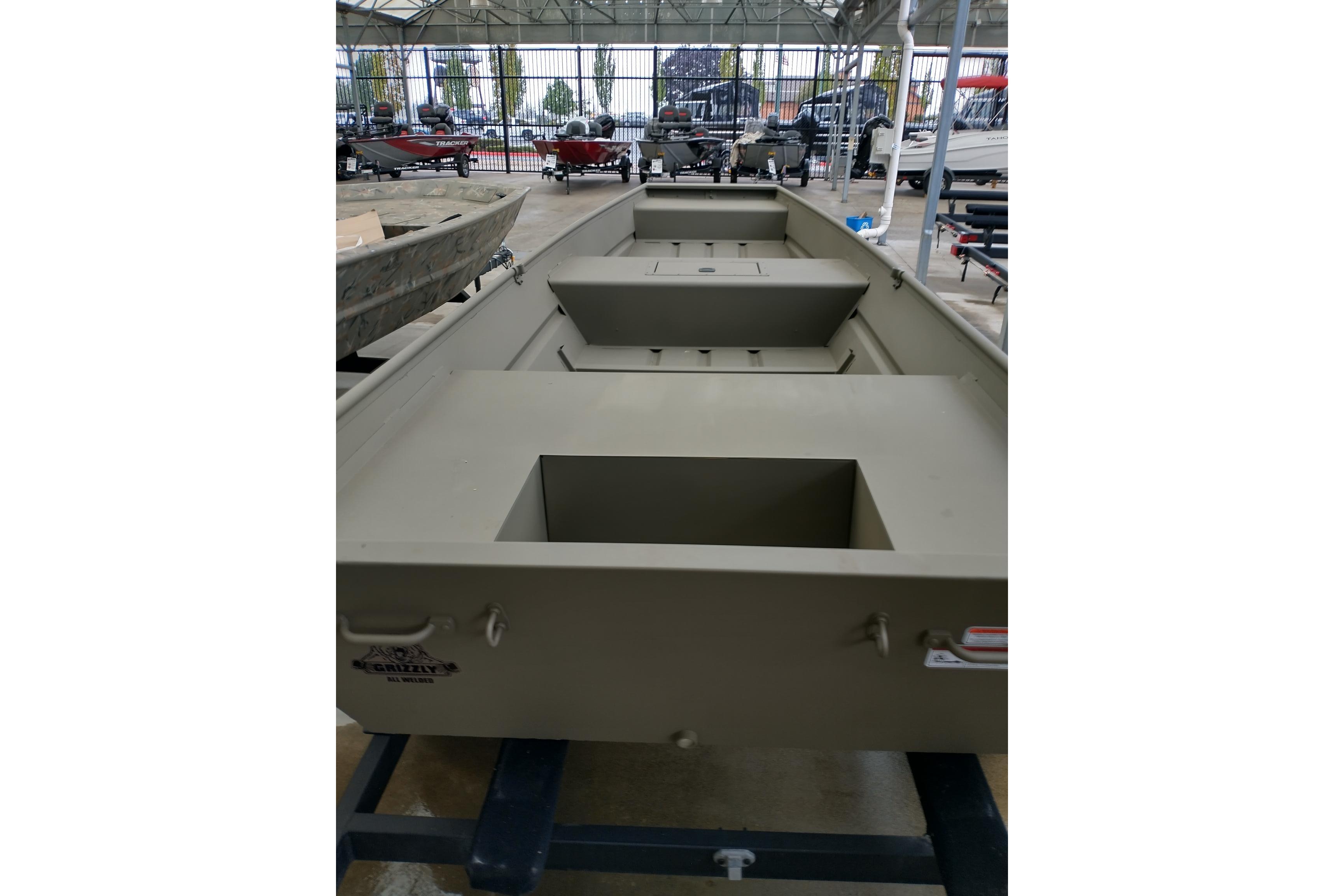 2026 Tracker Grizzly 15 Jon boat displayed in a showroom, showcasing its spacious interior.