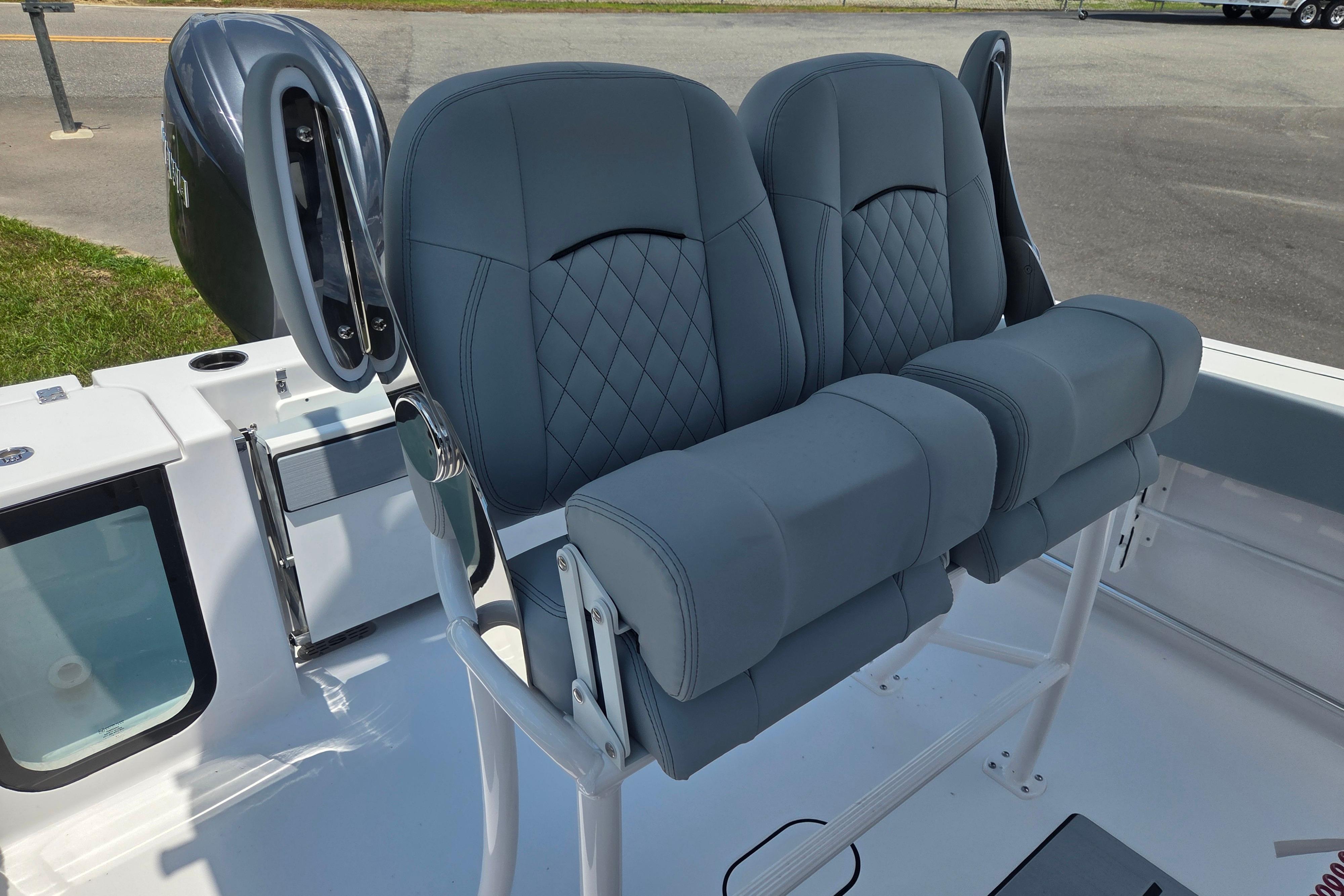 2026 Sportsman Open 212 Center Console boat with dual cushioned seats and motor.