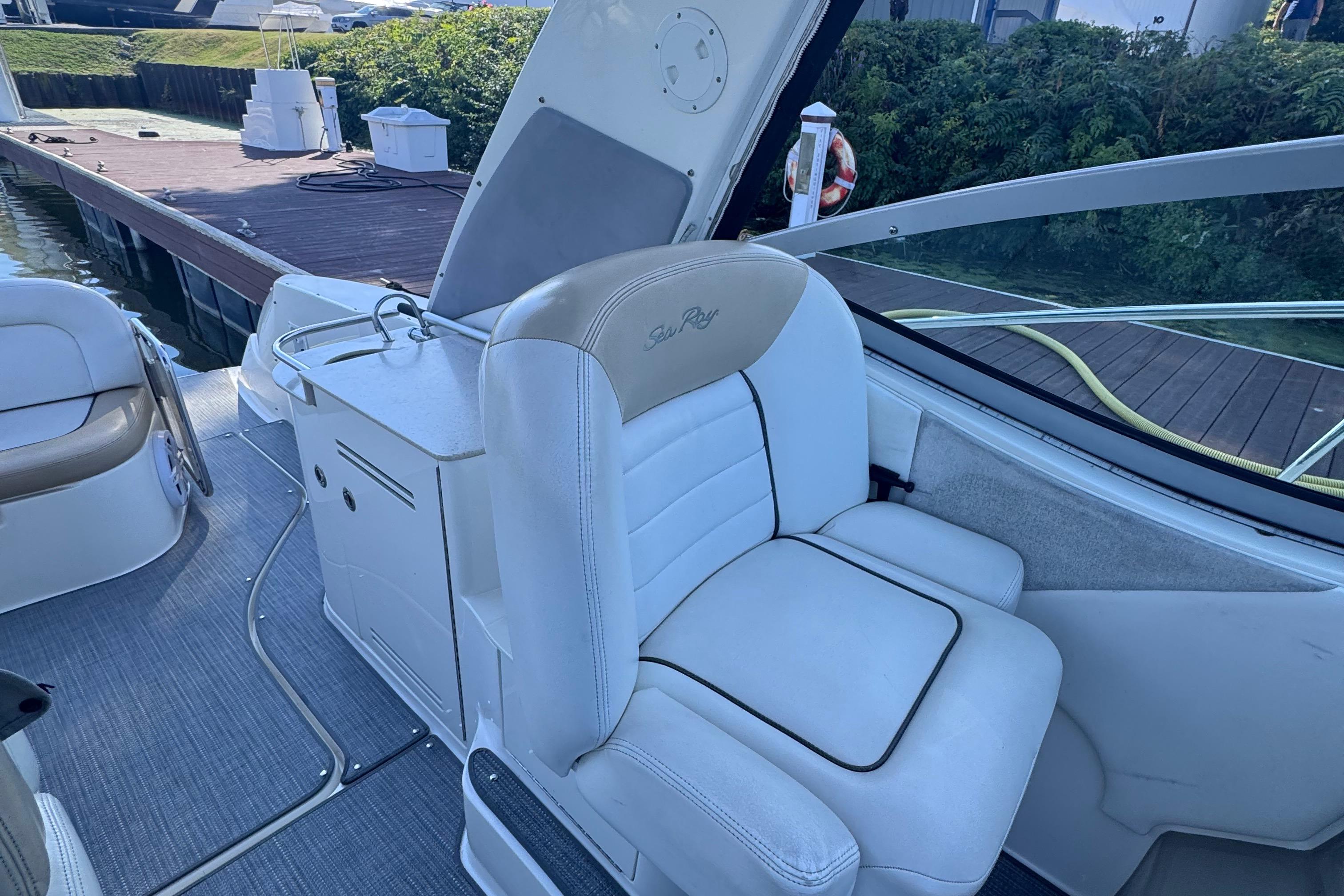 2008 Sea Ray 350 Sundancer boat interior with white seating and helm station.