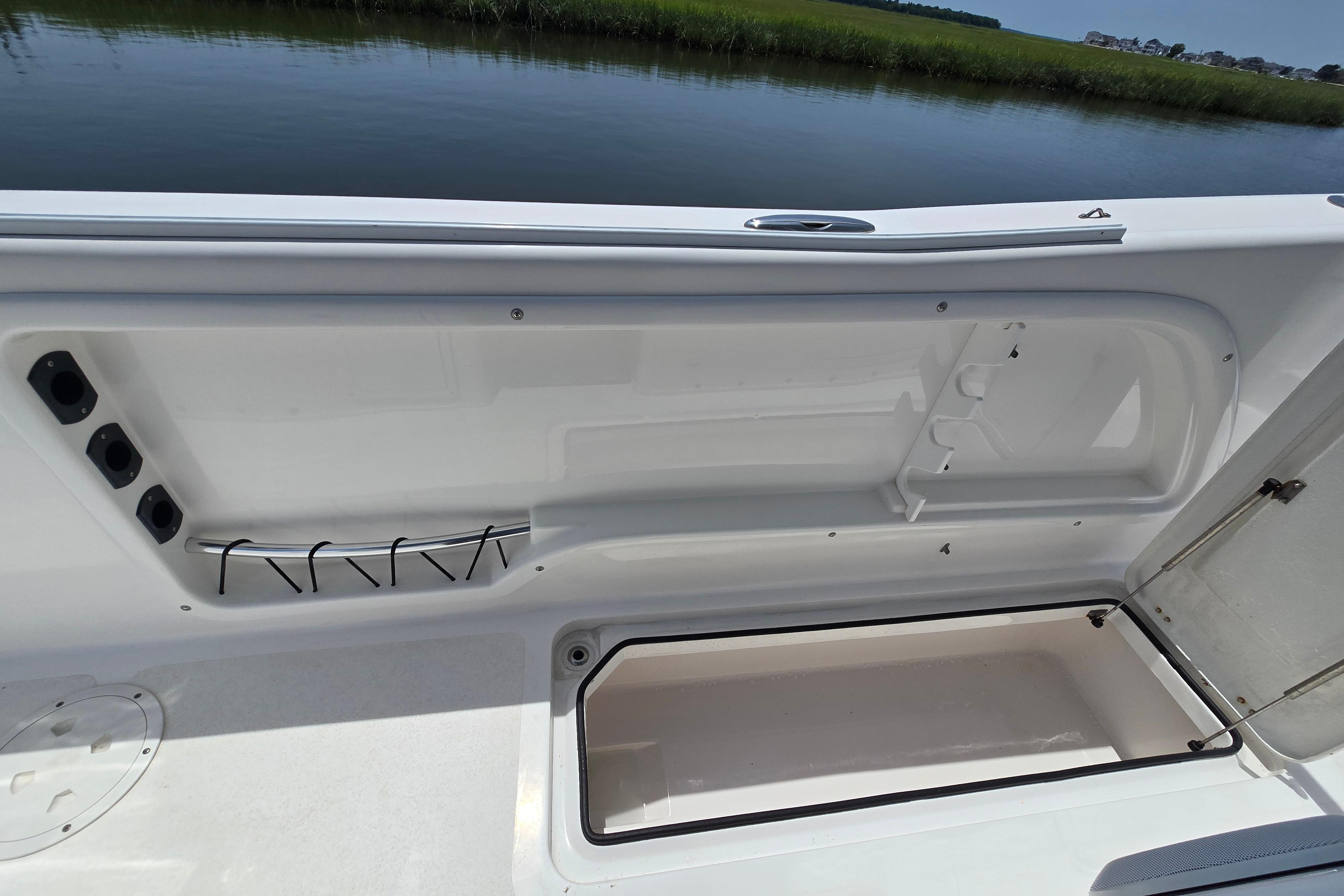 2021 Twin Vee 280 GFX CC boat interior storage compartment by the water.