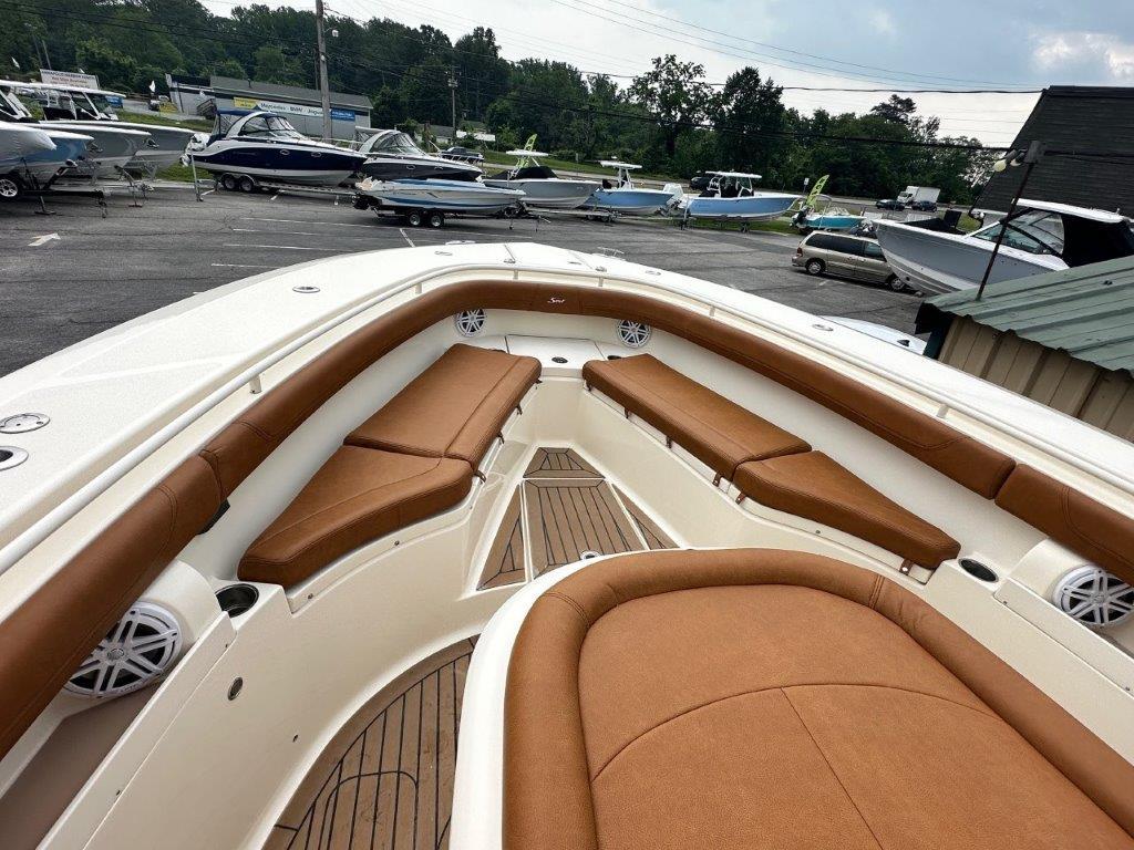 2018 Scout 350 LXF boat with tan seating, docked in a marina.