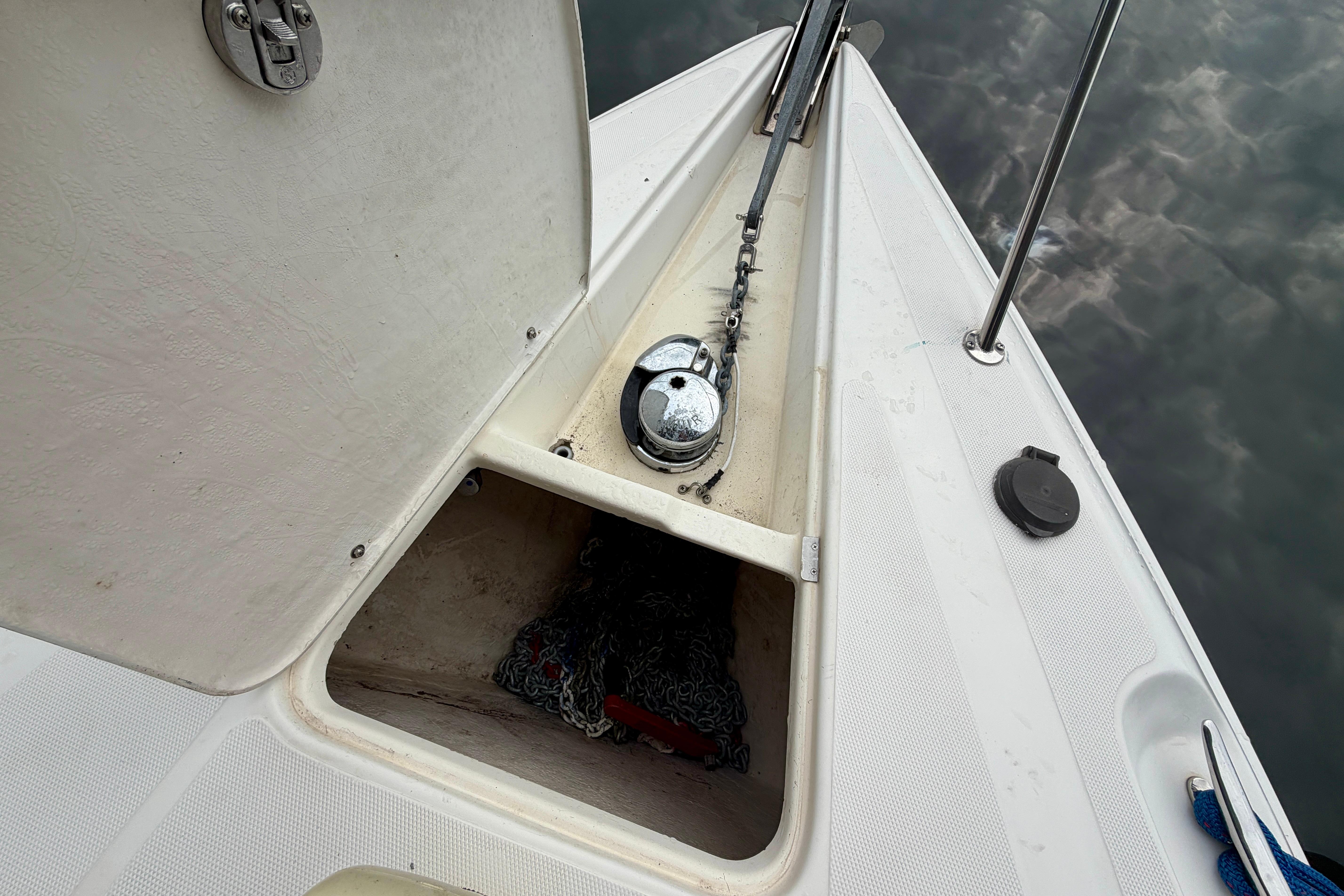 Anchor compartment of a 1999 Wellcraft 45 Excalibur boat, open with visible chain.