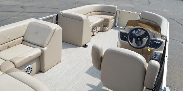 2018 Tahoe LTZ 2285 CR pontoon boat interior with beige seating and steering console.