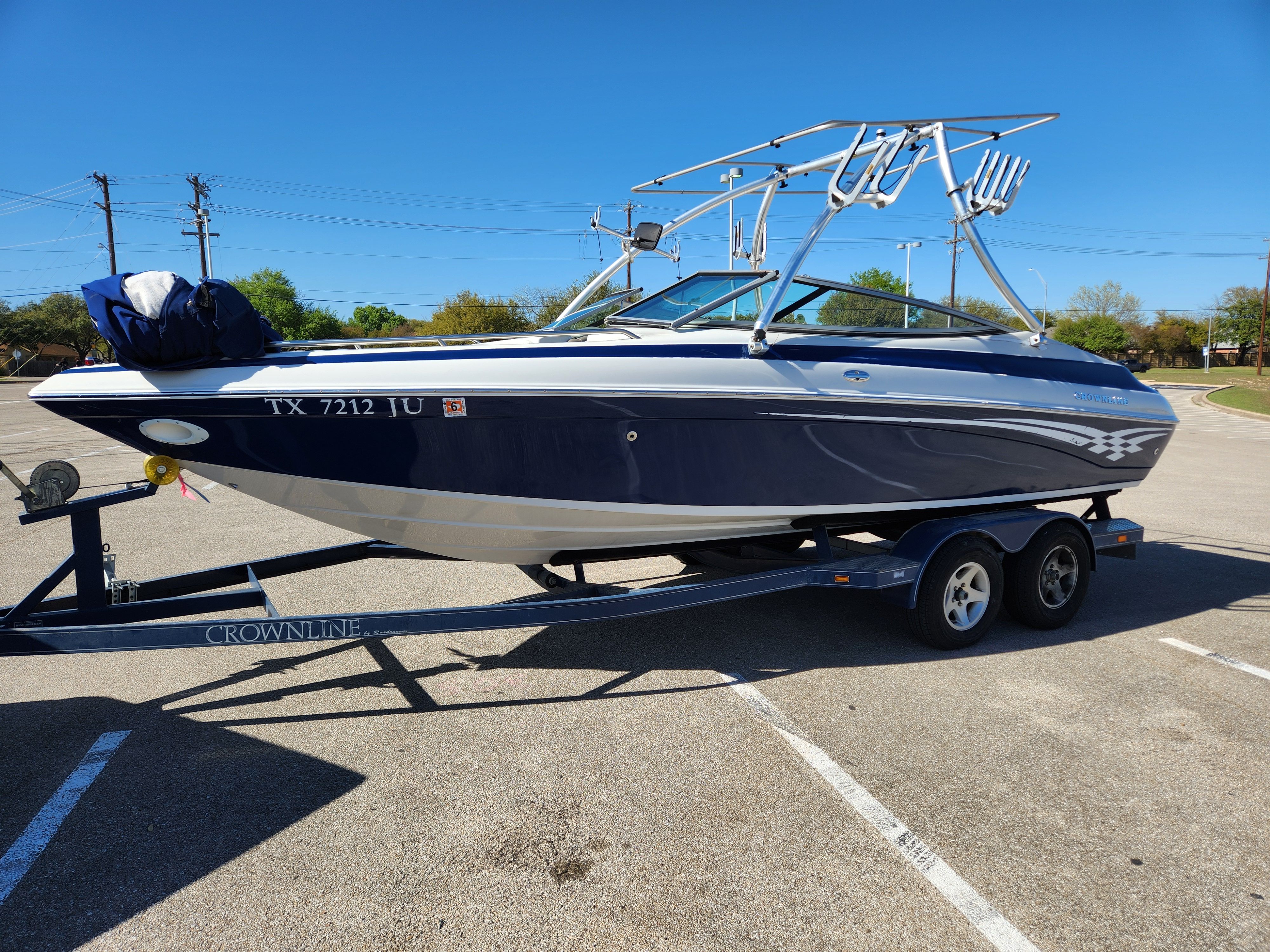 2003 Crownline 225 BR boat on trailer, blue sky.