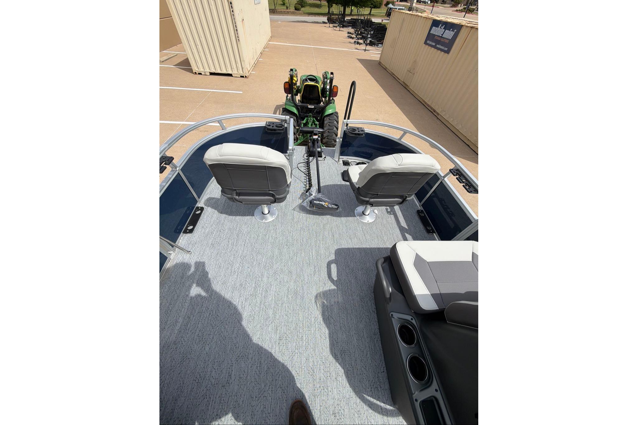 2026 Sun Tracker Bass Buggy 16 XL Select pontoon boat interior with seating and steering console.