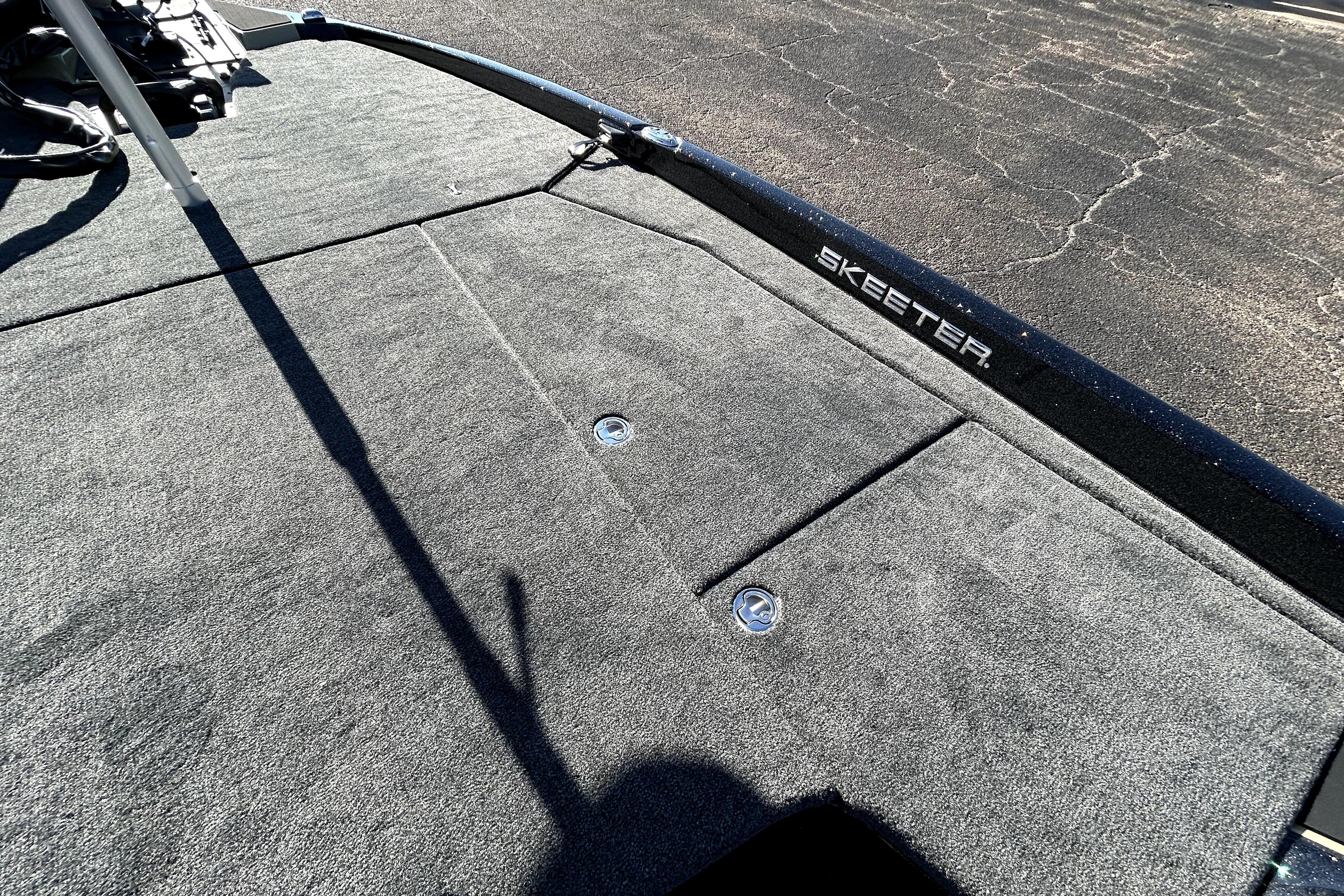 2026 Skeeter ZXE21 boat deck with carpeted surface and storage compartments.