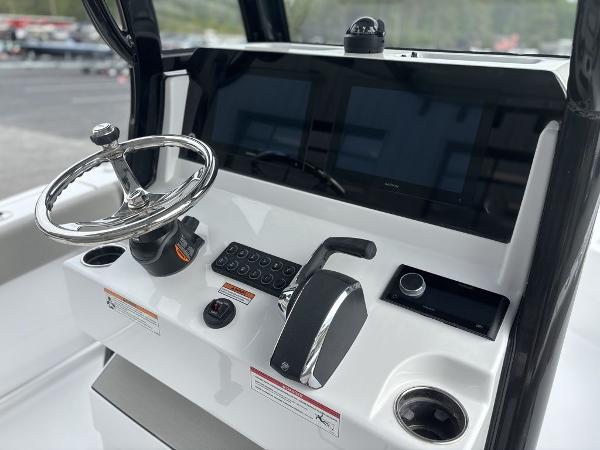 2025 Sportsman Open 232 boat dashboard with steering wheel and control panel.