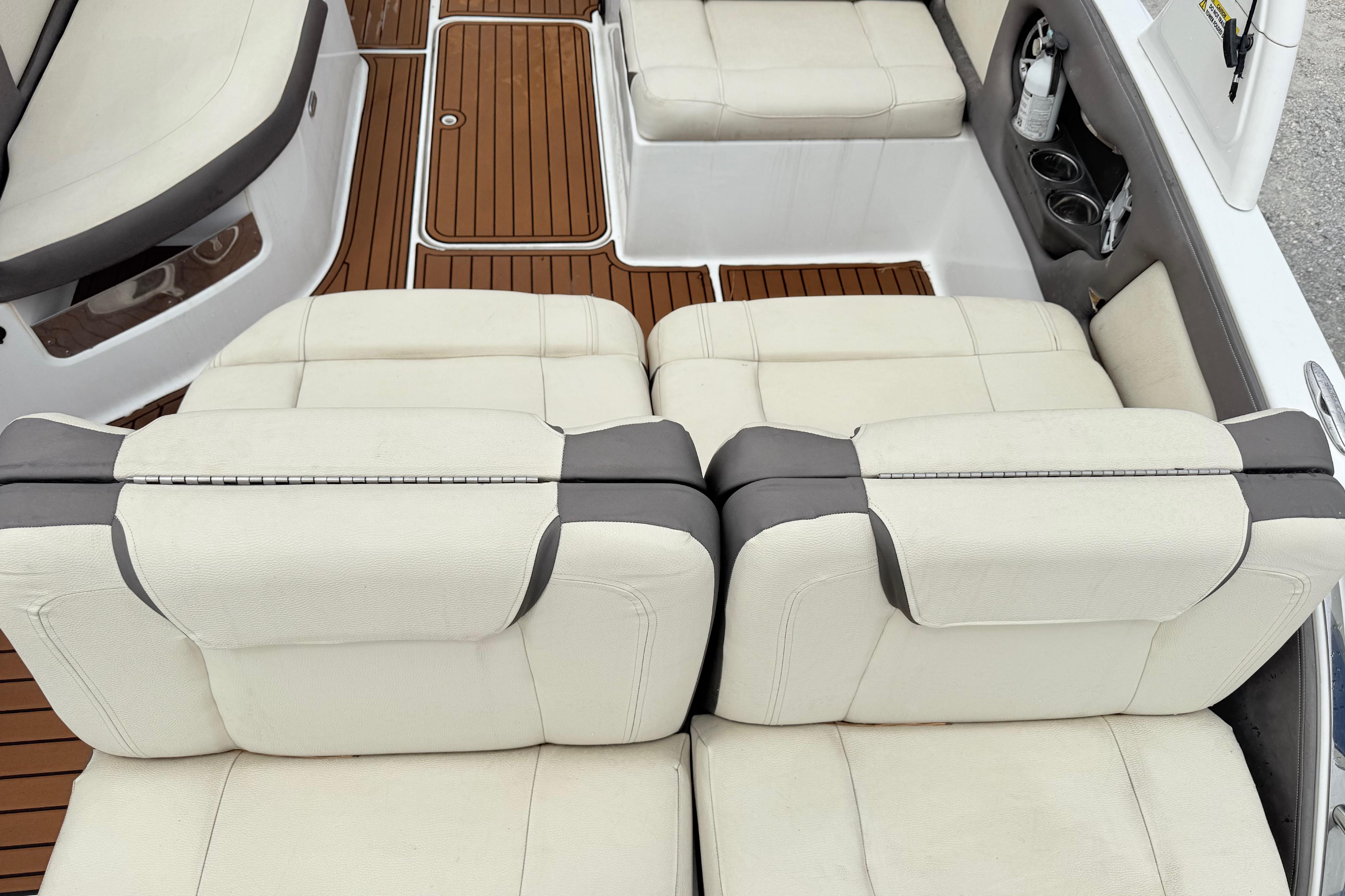 Luxurious seating on a 2018 Bryant Calandra boat with elegant white upholstery and wood flooring.