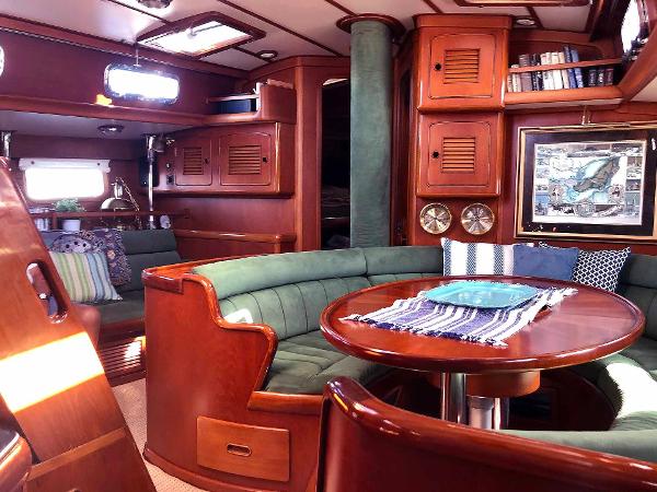 Interior of a 1988 Little Harbor 53 with elegant woodwork and a cozy seating area.