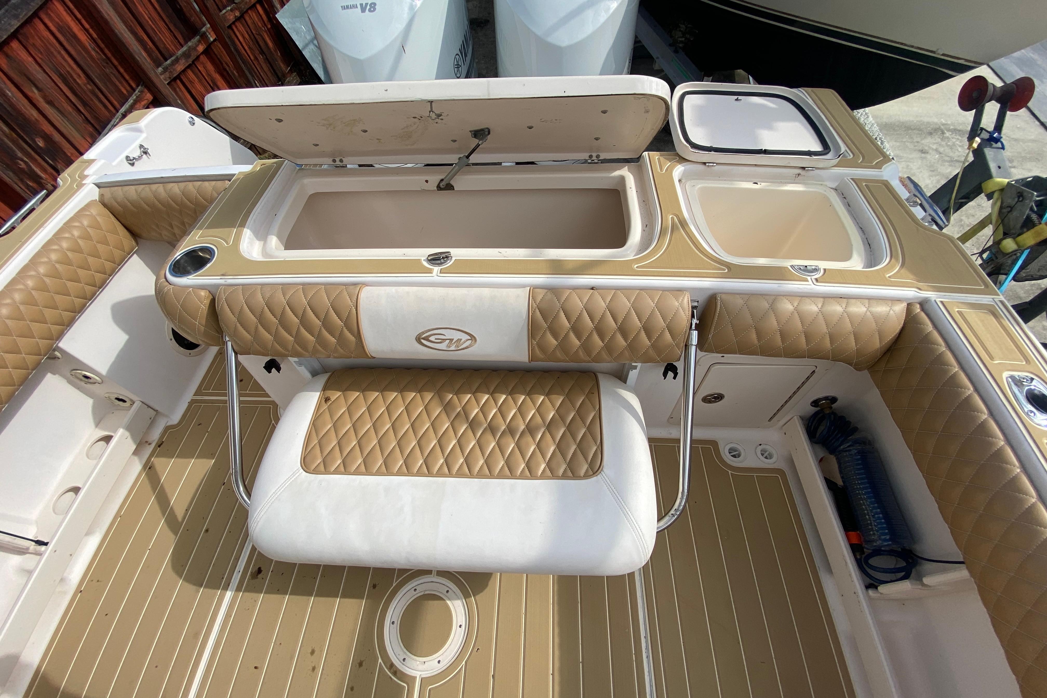2004 Grady-White Canyon 283 boat interior with tan quilted seating and storage compartments.