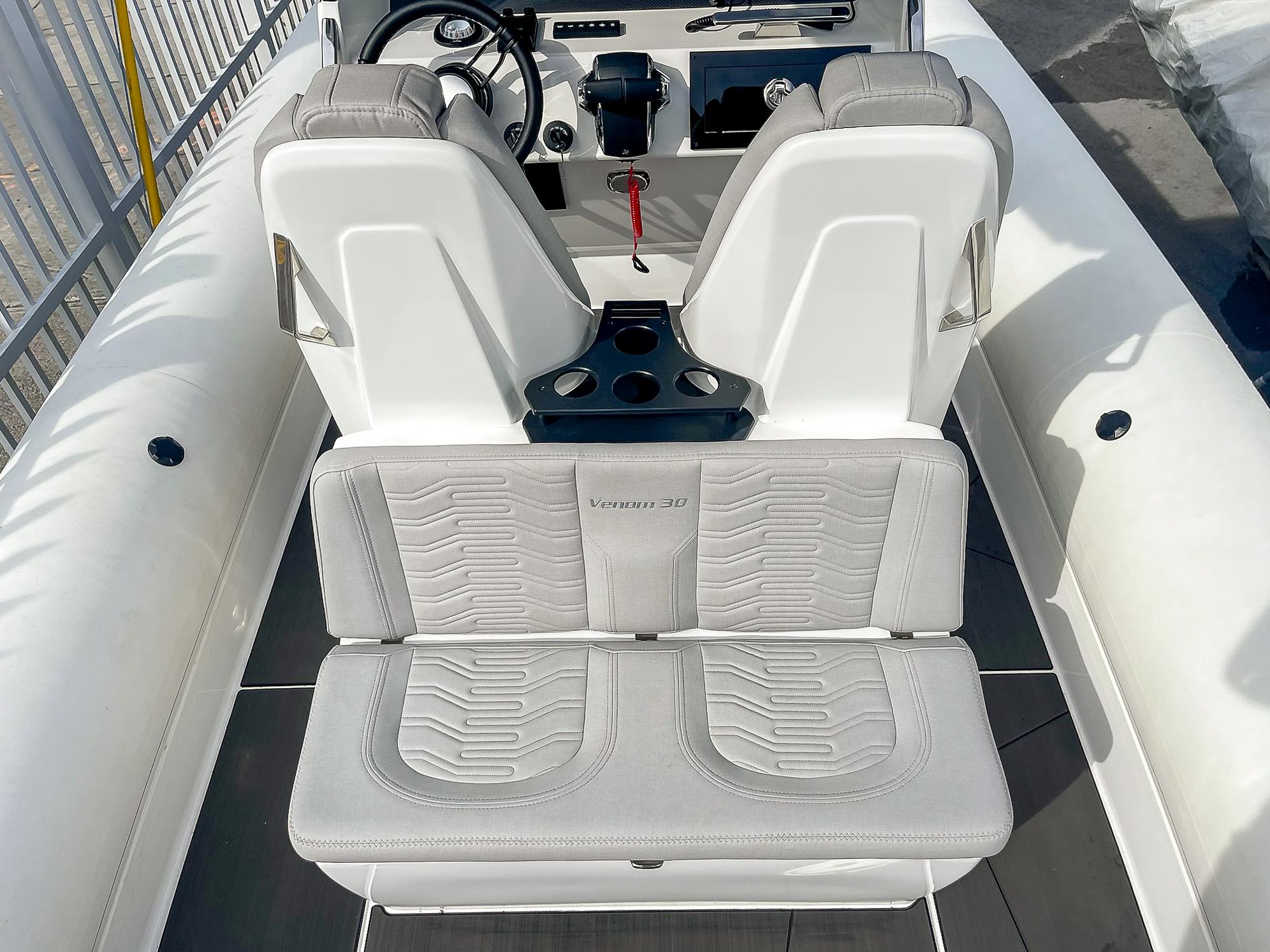 2025 Ribco Venom 30 boat interior with white seating and modern dashboard.