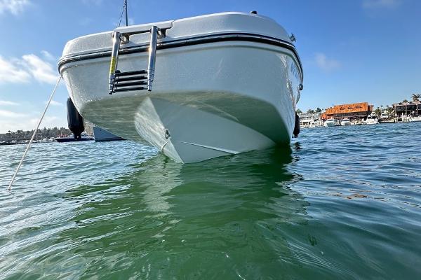 2024 Bayliner DX 2250 boat on water, showcasing sleek hull design.