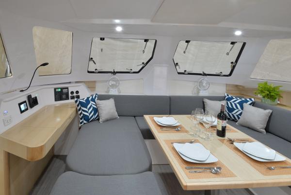 Modern interior of 2025 Seawind 1170 yacht with dining table set for four.