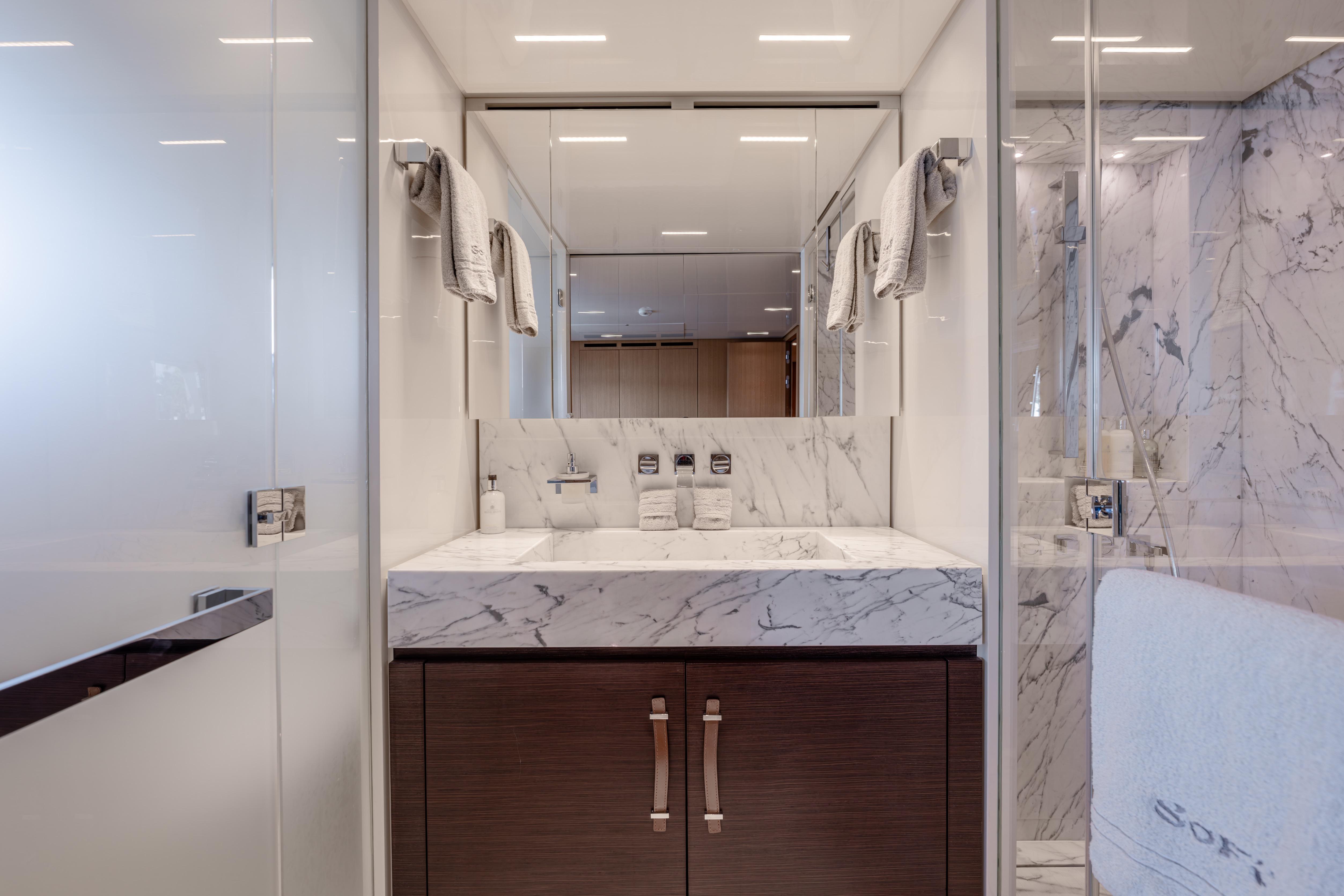 Luxurious bathroom in 2023 Sanlorenzo SL120A yacht with marble sink and modern fixtures.