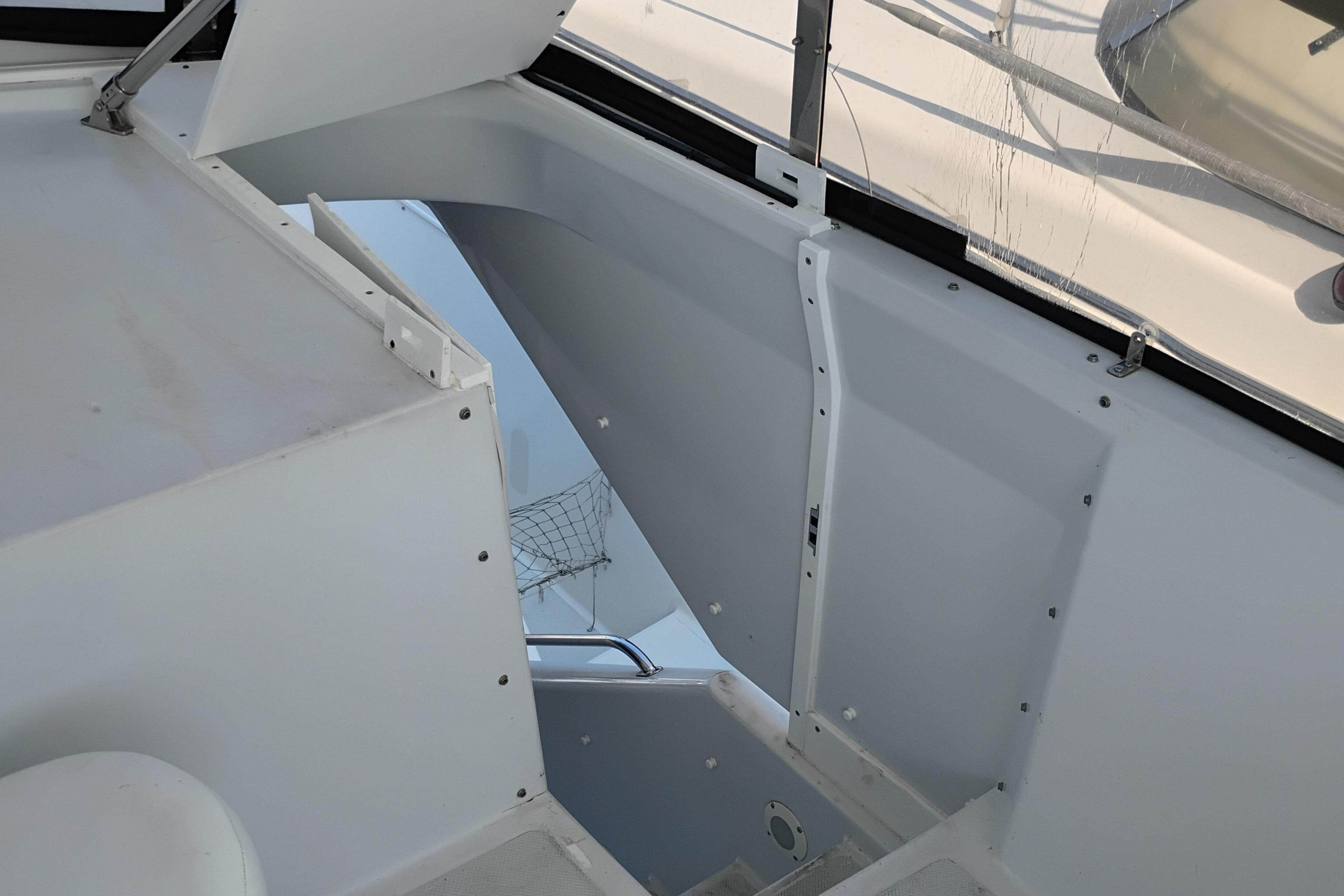 Interior view of 1995 Queenship 62 Pilothouse Motor Yacht, showcasing sleek white design.