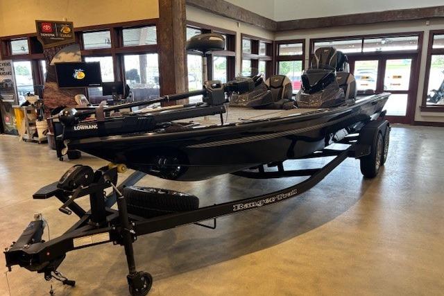 2025 Ranger ALPHA 208 boat on display in showroom, featuring sleek black design.