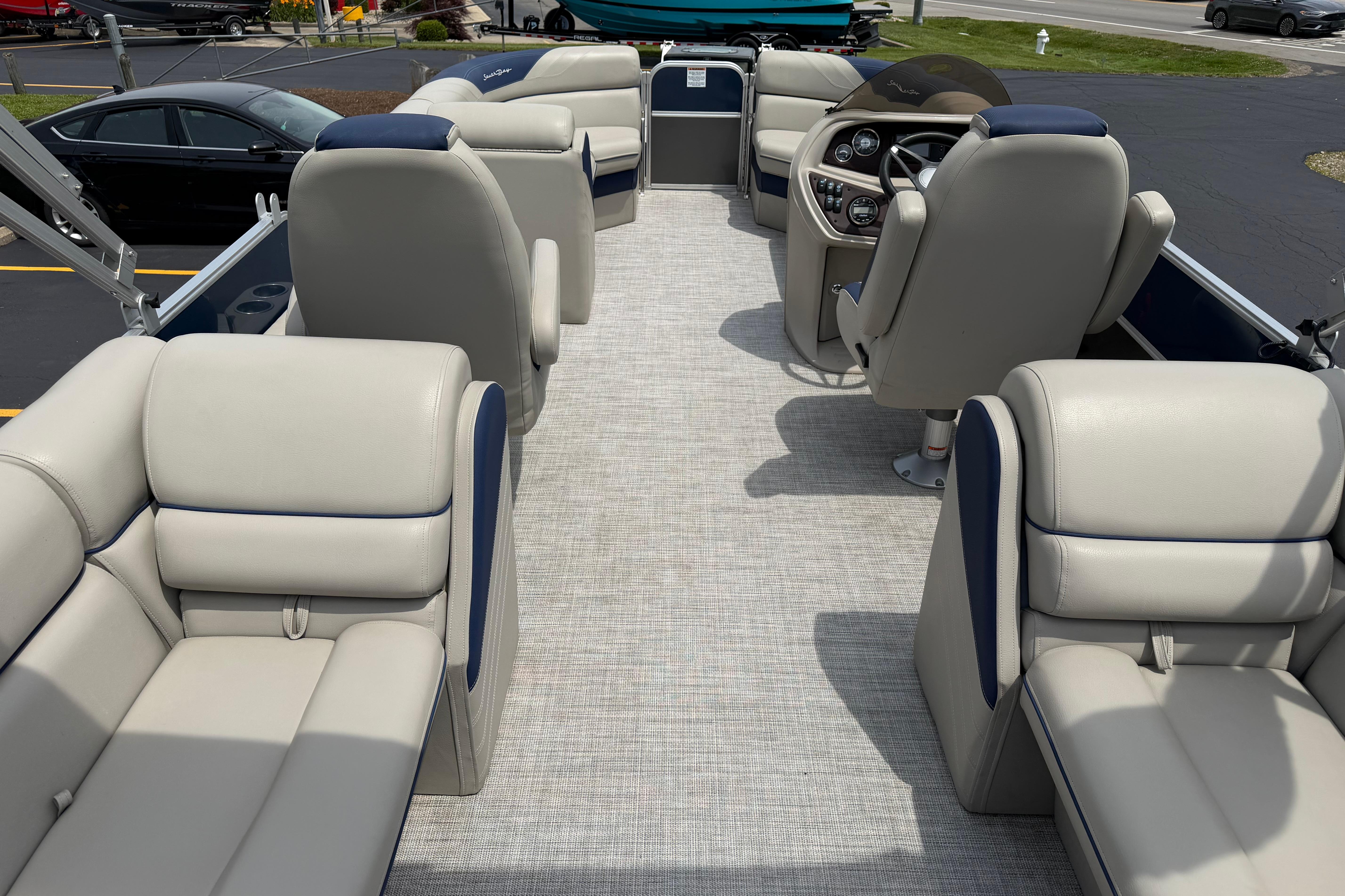 2021 South Bay 224RS LE pontoon boat interior with plush seating and modern dashboard.