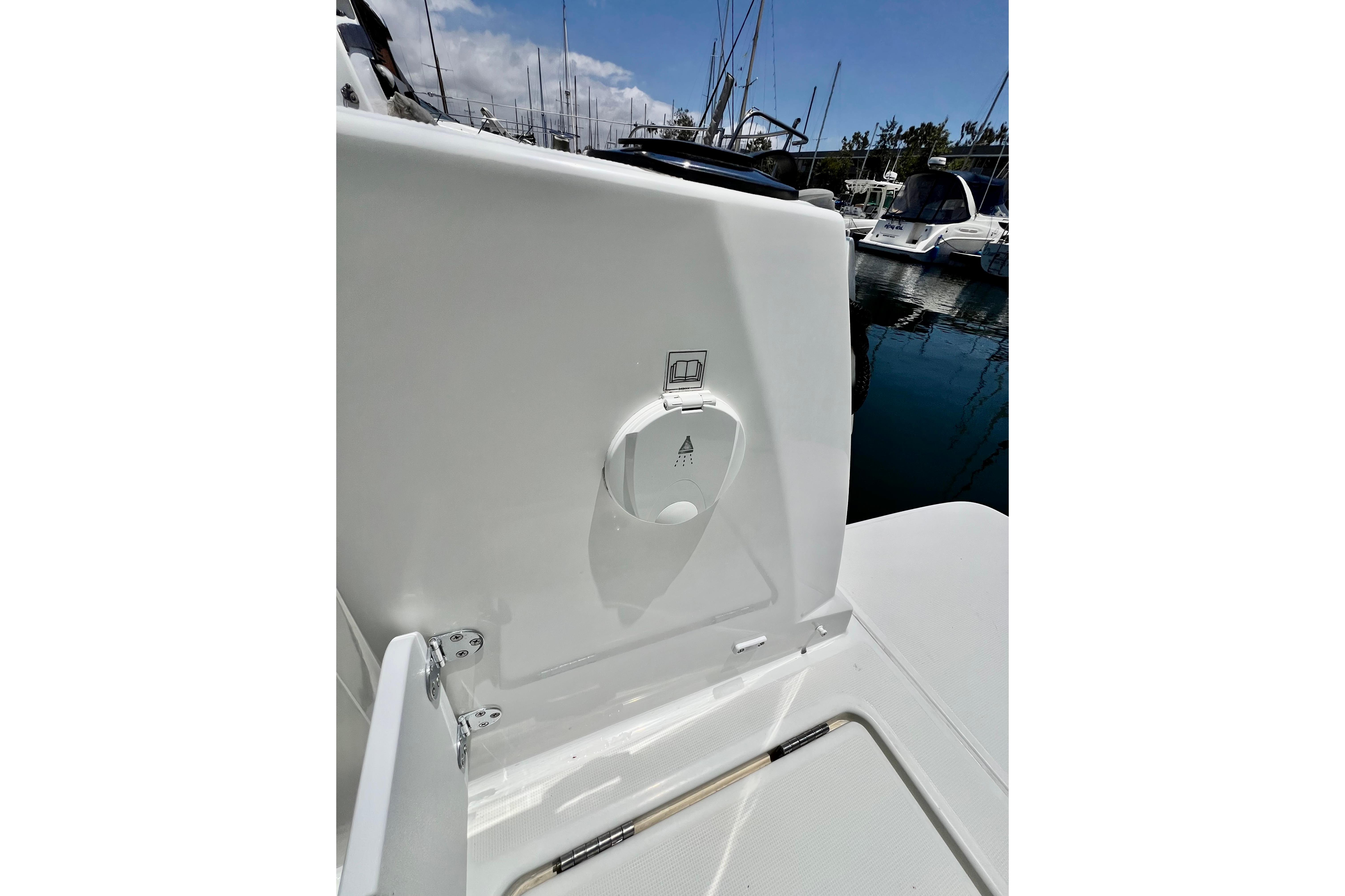 2023 Beneteau Antares 8 boat detail, featuring a sleek white exterior in a marina setting.