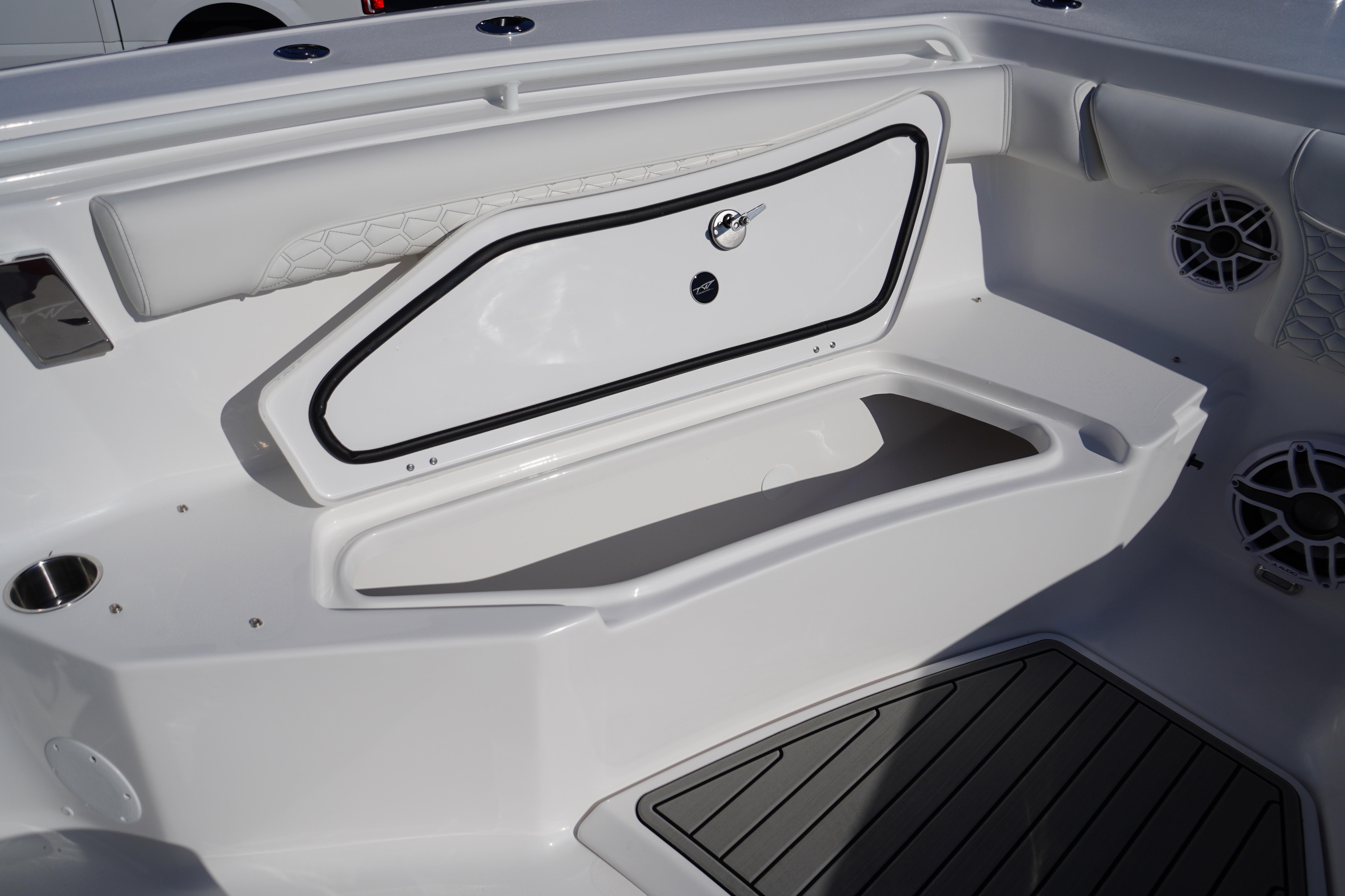 2026 Tidewater 272 LXF boat interior with storage compartment and seating area.