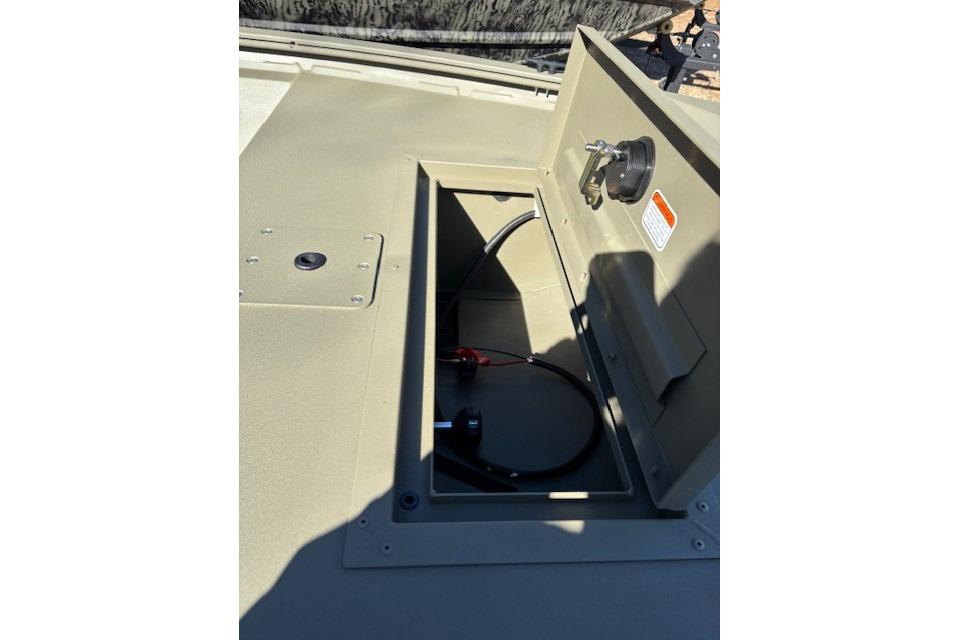 Open storage compartment on 2026 Tracker Grizzly 1648 SC boat, showing interior cables.