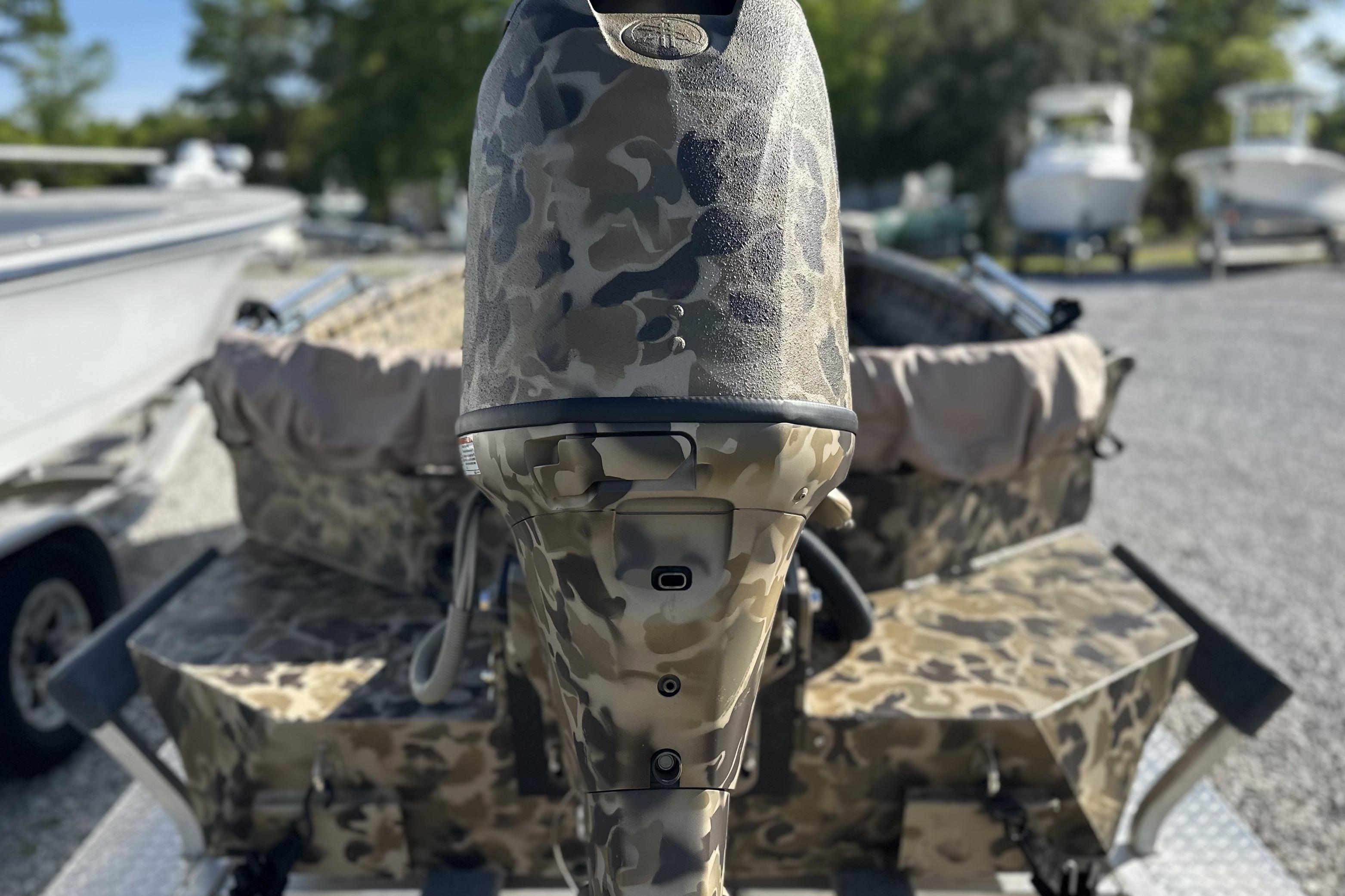 Camouflage-patterned Excel 1751 Viper F4 boat motor, 2026 model, in a marina setting.