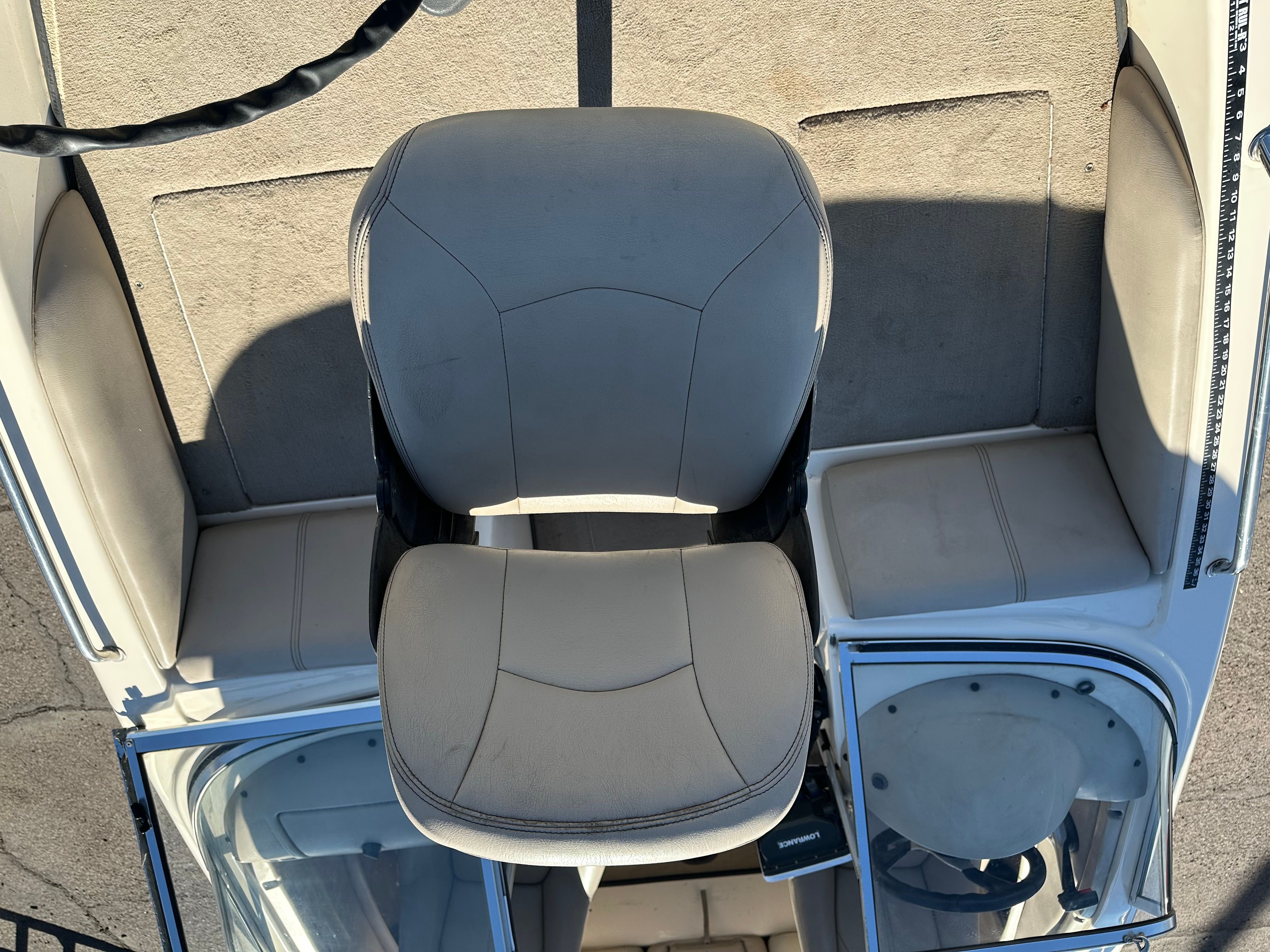 A boat with a central seat and two side seating areas.