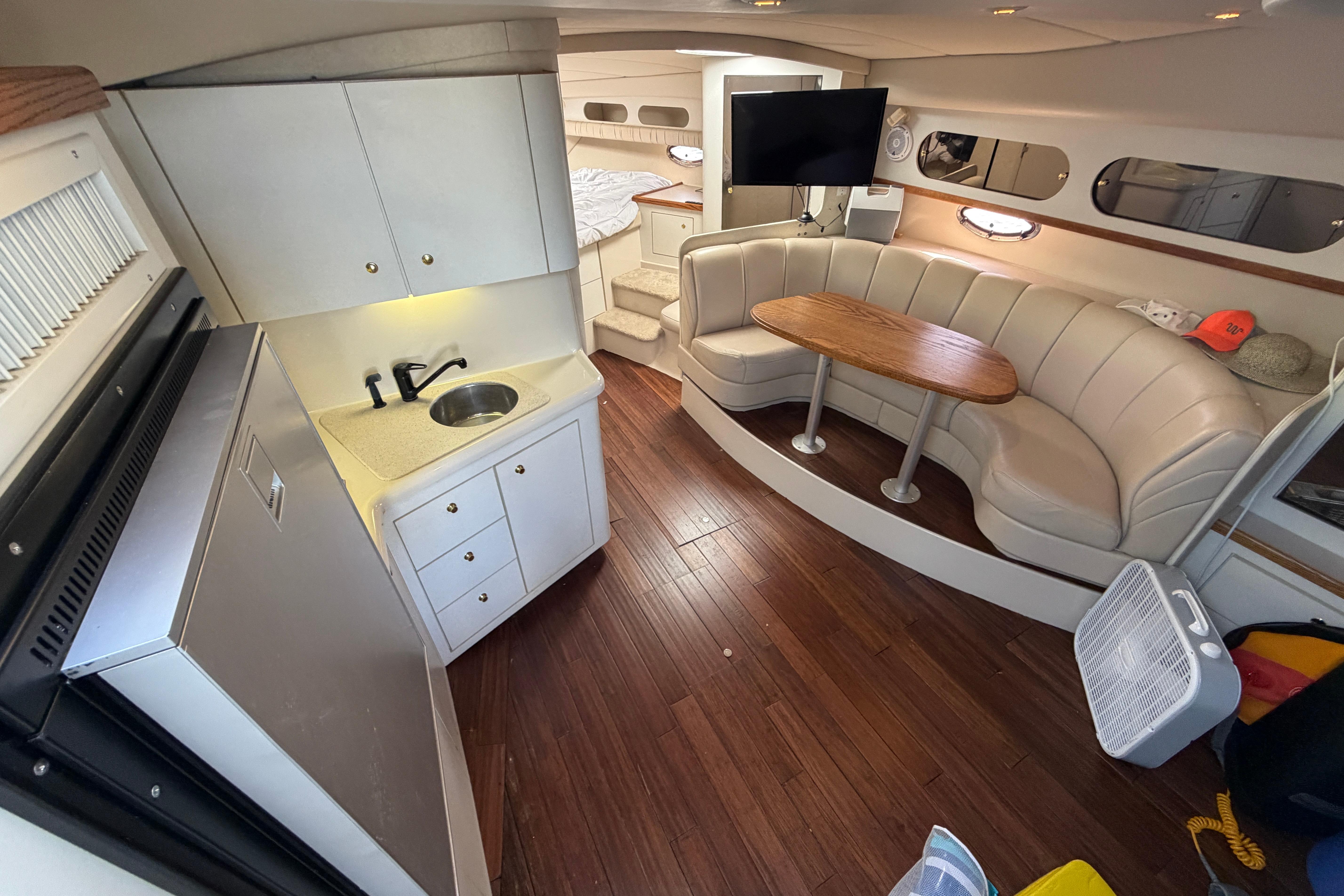 Interior of a 1997 Cruisers 3575 yacht with kitchenette and seating area.