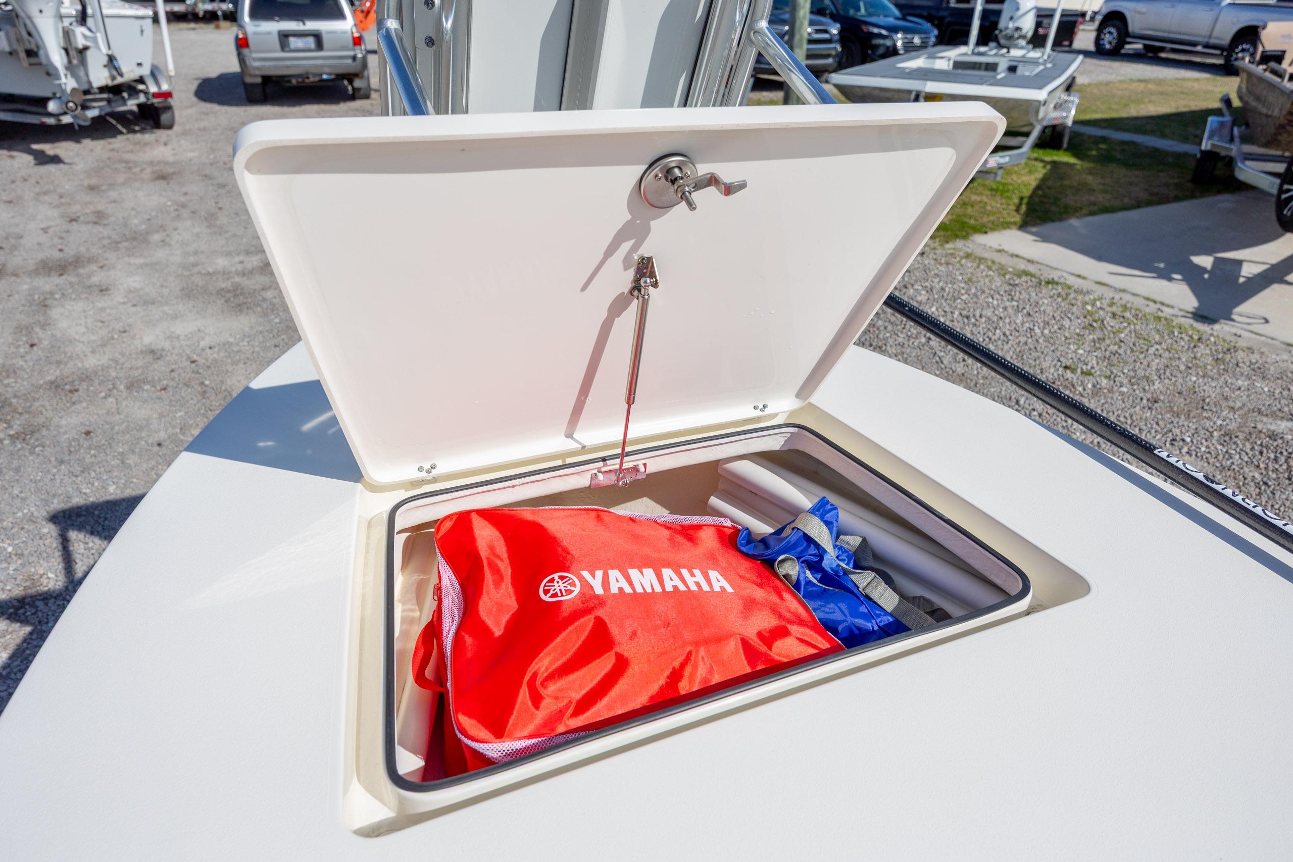 2024 Maverick 17 HPX-S boat storage compartment with Yamaha gear inside.
