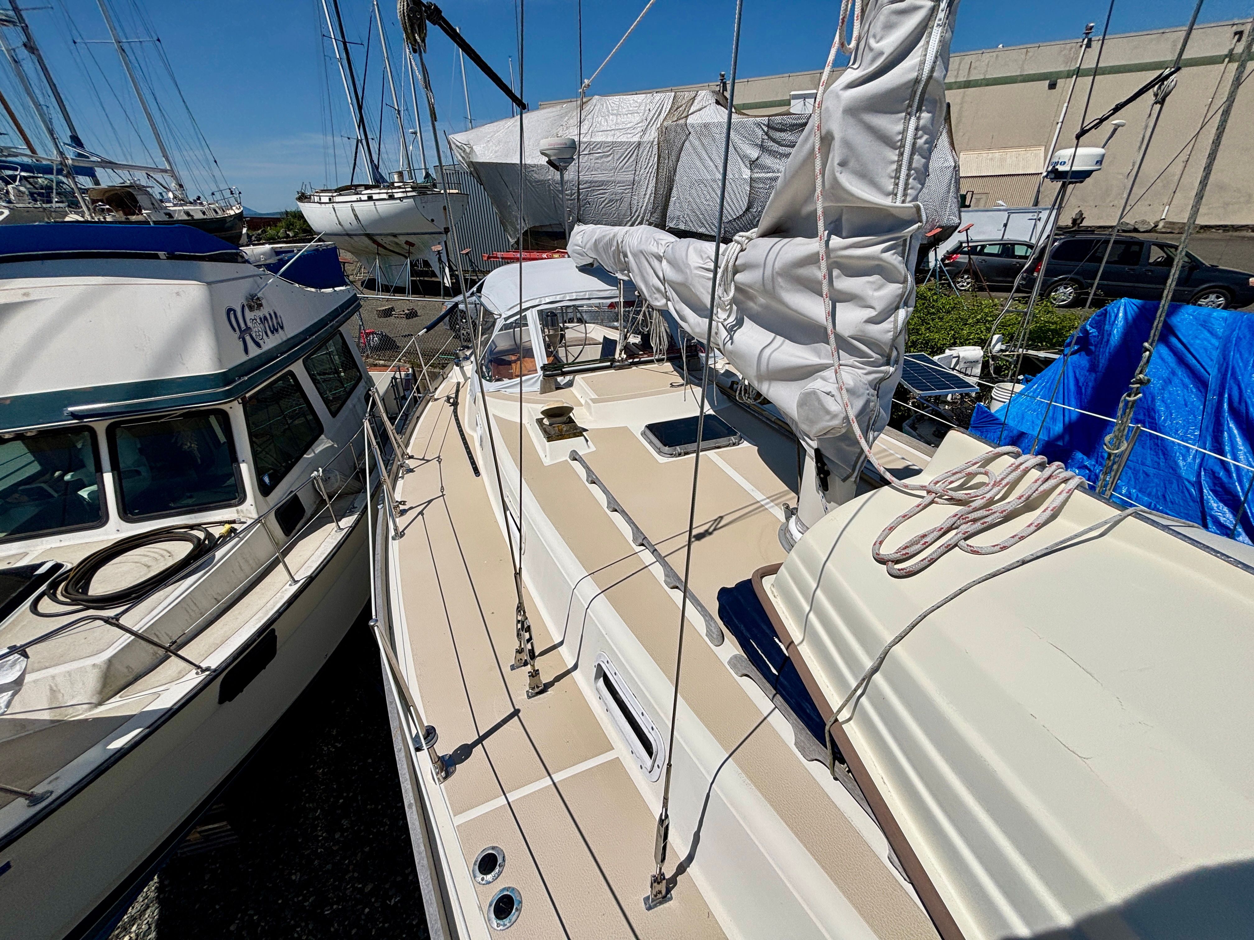 1979 Tartan 37 sailboat docked, with sails and neighboring boats visible.