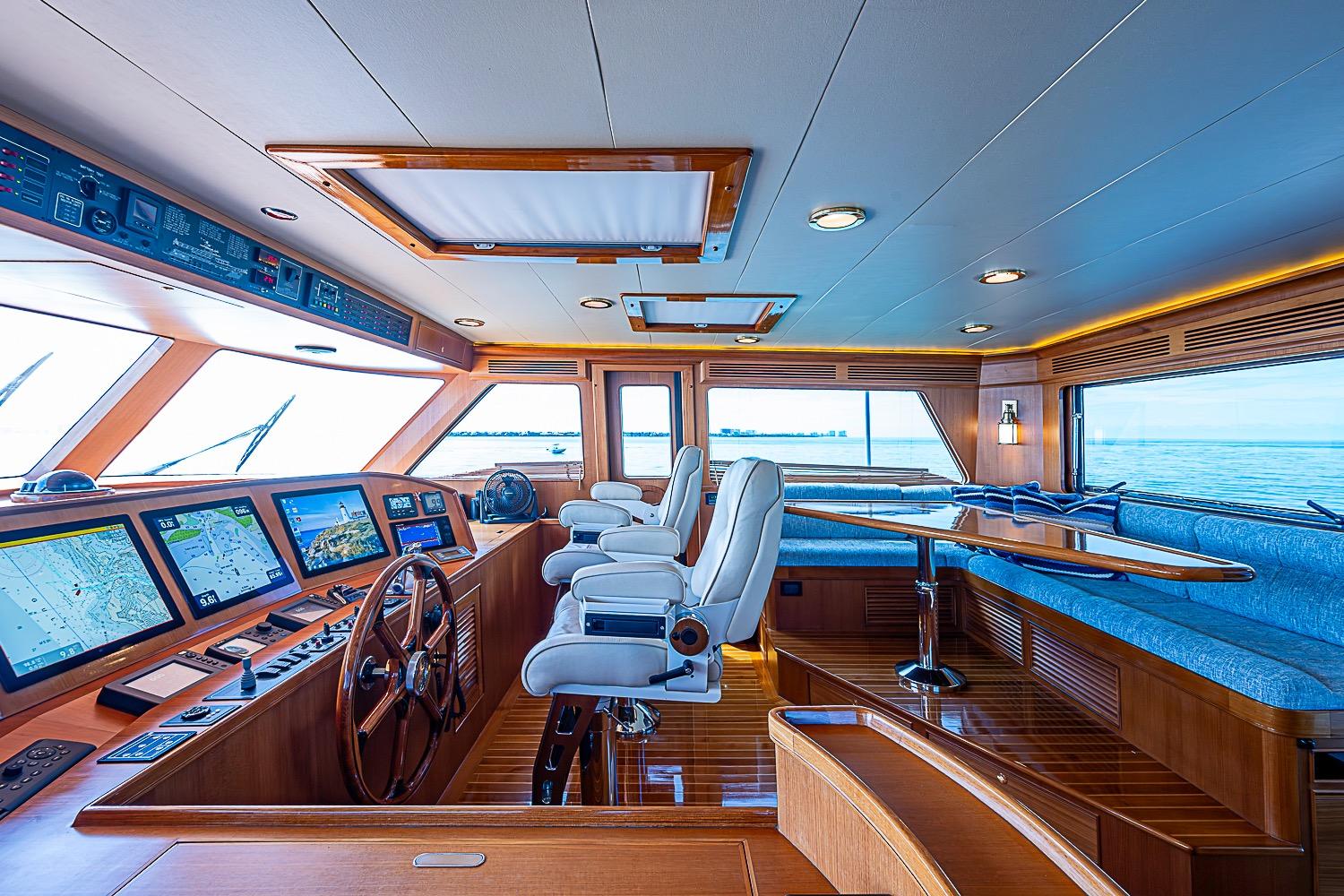 Luxurious interior of 2014 Marlow 80 Explorer yacht with navigation screens and seating area.