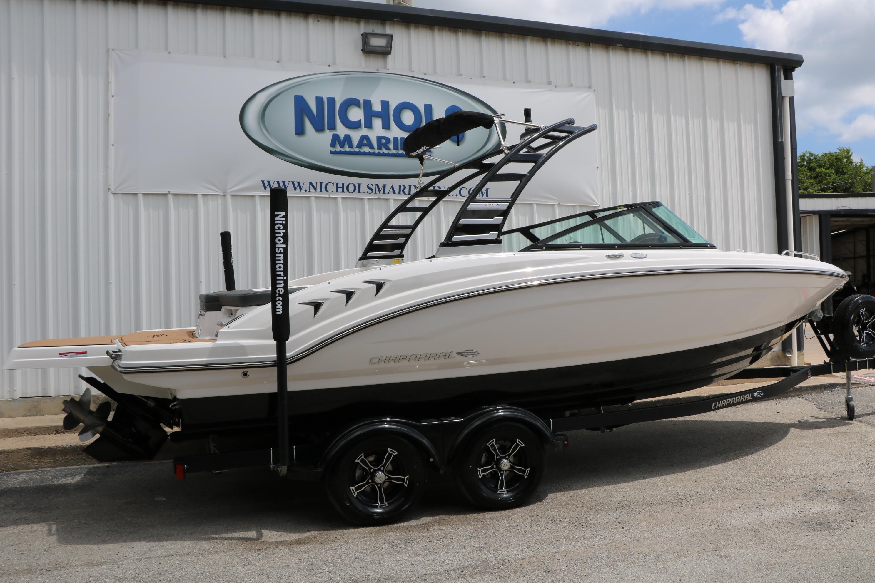 2025 Chaparral 23 SSi boat on trailer at Nichols Marine dealership.