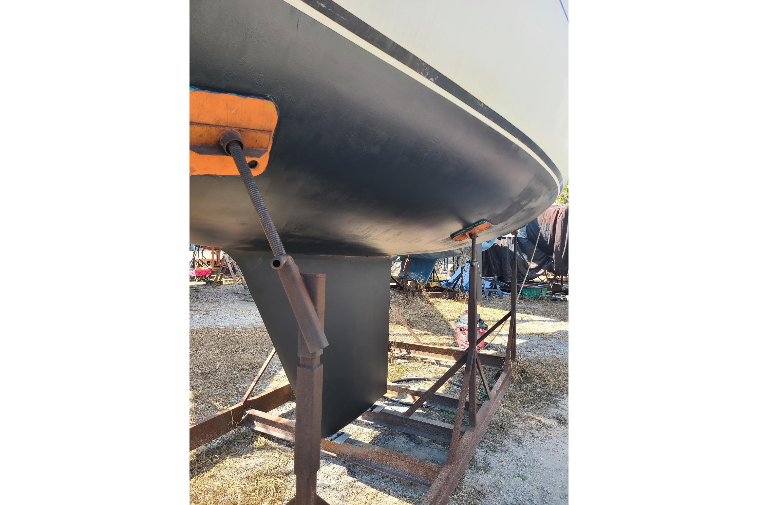 1986 Tartan 34-2 sailboat hull on a stand, showcasing keel and rudder.