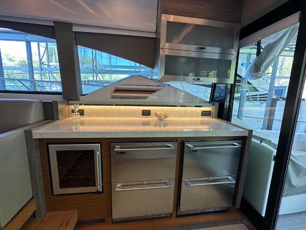Modern kitchen area in 2019 Tiara Yachts C53 with stainless steel appliances.