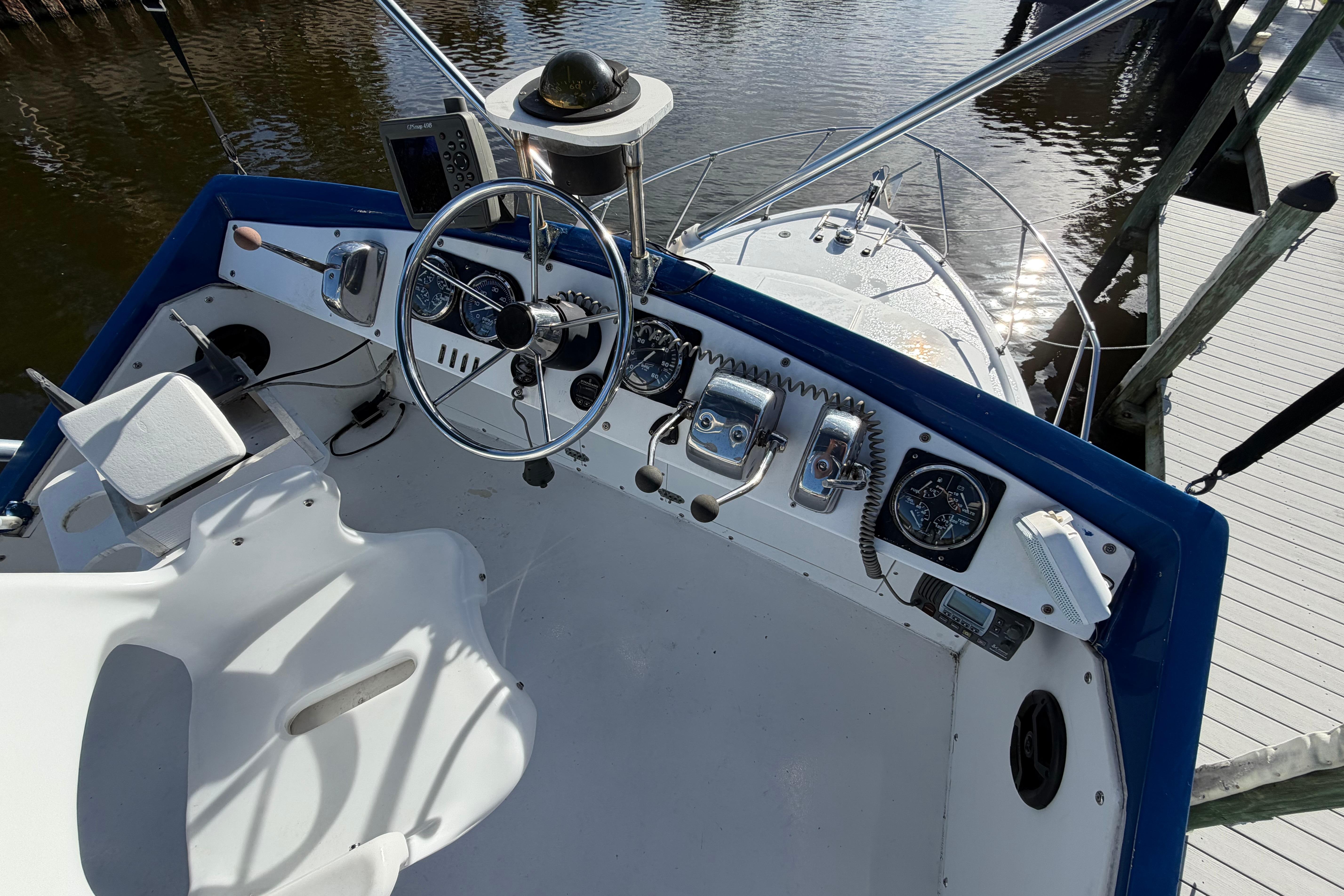 1973 Chris-Craft 30 Tournament FB boat helm with steering wheel and controls.